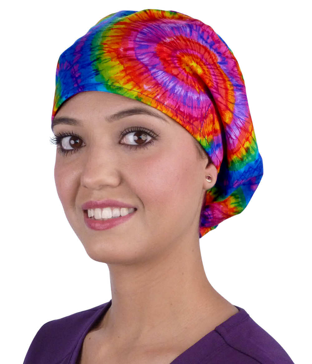 Front facing image of a woman in scrubs wearing a Tie Dye Euro Style Riley Comfort Scrub Cap.