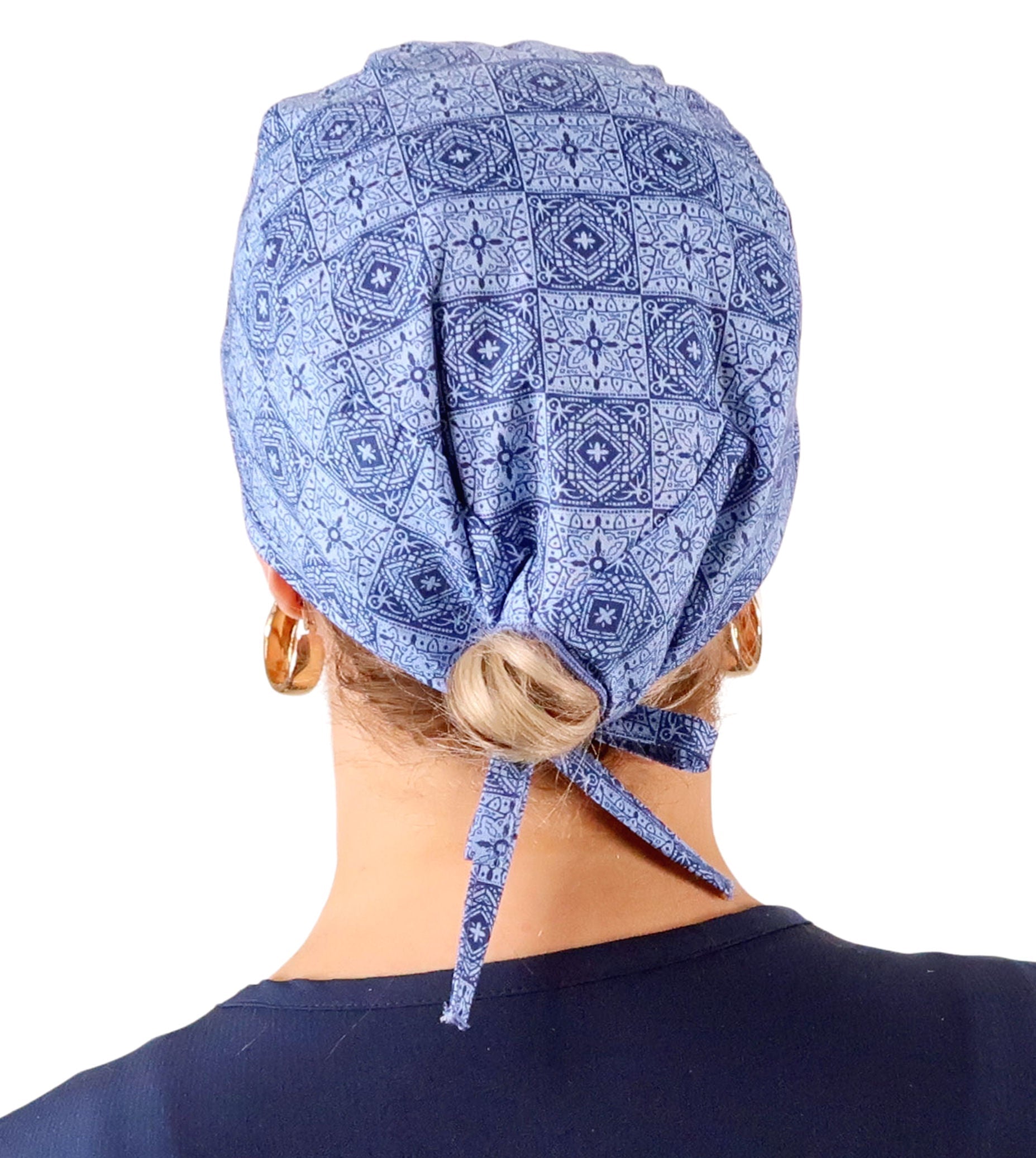 Back Facing View of a Woman Wearing a Classic Cotton Surgical Scrub Cap - Tuscan Blue Tiles Pattern.