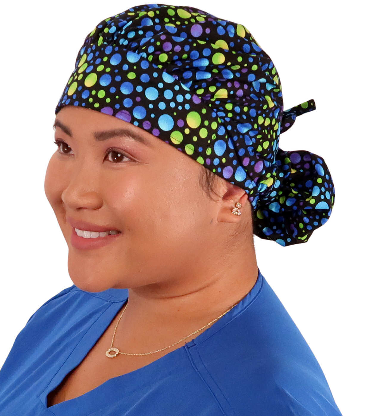 Front Facing Tied View of a Woman Wearing a Tied Back Banded Bouffant Ponytail Surgical Scrub Cap - Blue, Green and Purple Dots Patterned Fabric  