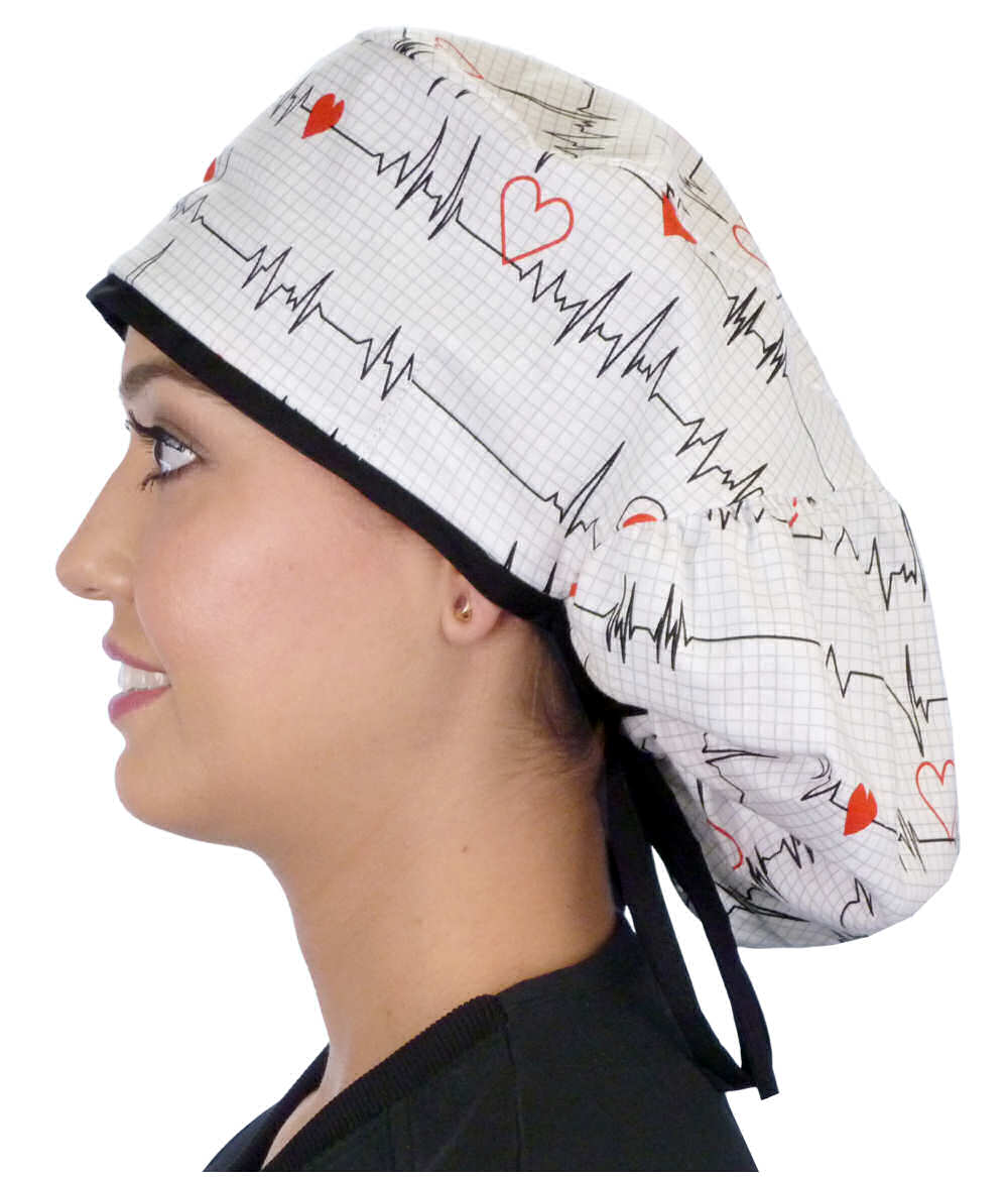 Side facing untied image of a woman in scrubs wearing a Big Hair Ponytail Scrub Cap with a Heartbeats on White pattern, and black ties to hold the scrub cap in place.