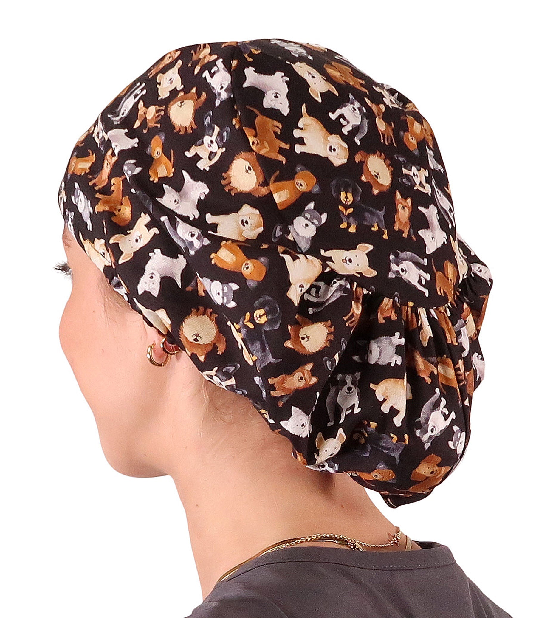 Side facing image of a woman in scrubs wearing a Puppy Parade Dogs Euro Style Riley Comfort Scrub Cap.