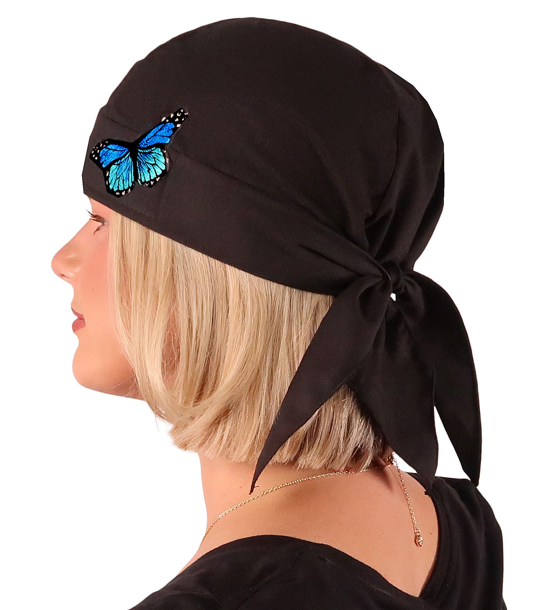 Side Facing View of a woman wearing a classic Skull Cap with a Blue Butterfly Patch on Black. 