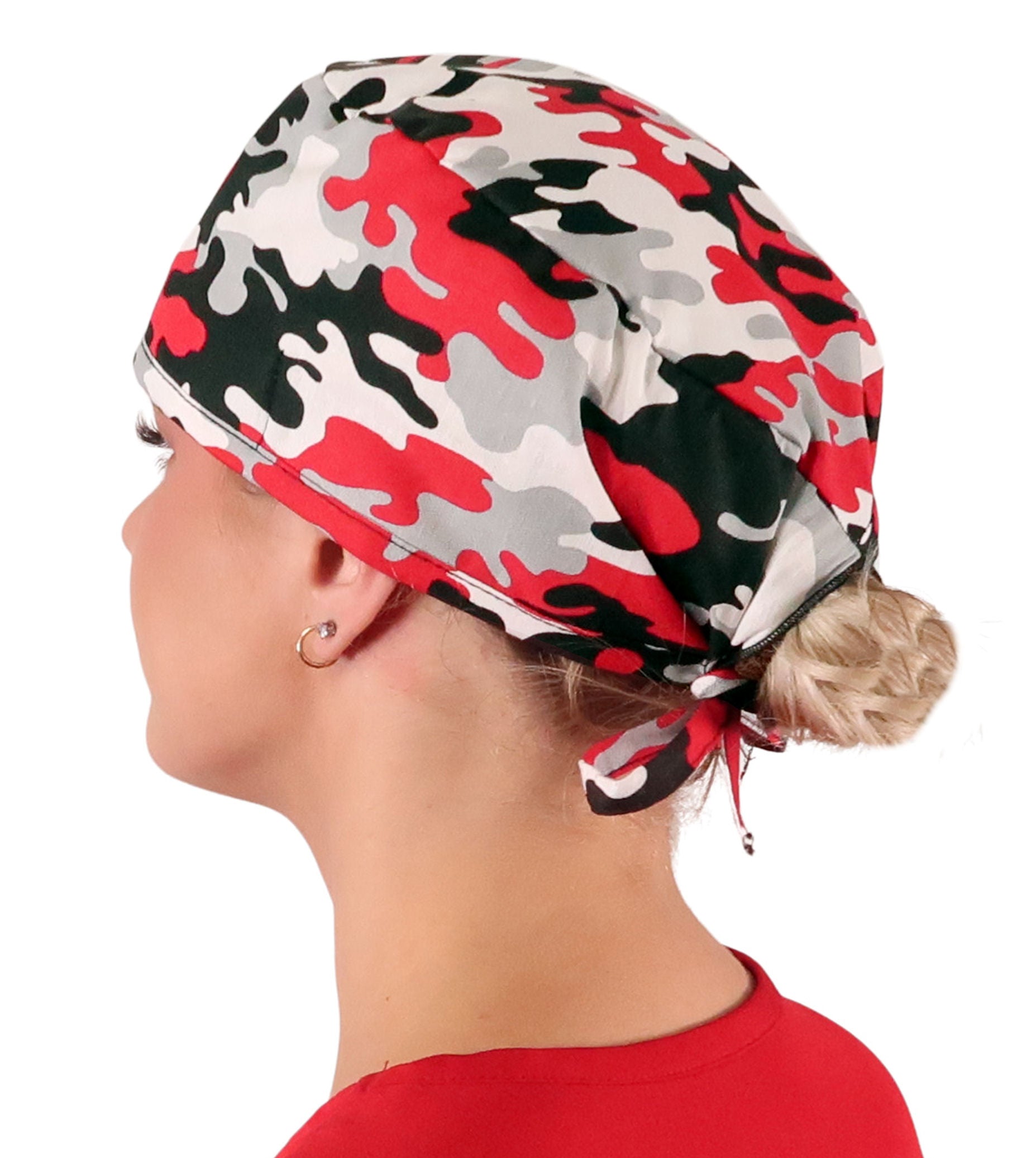 Side facing image of a woman in scrubs wearing a Classic Surgical Scrub Cap with a Red, Grey, Black and White Camouflage pattern.