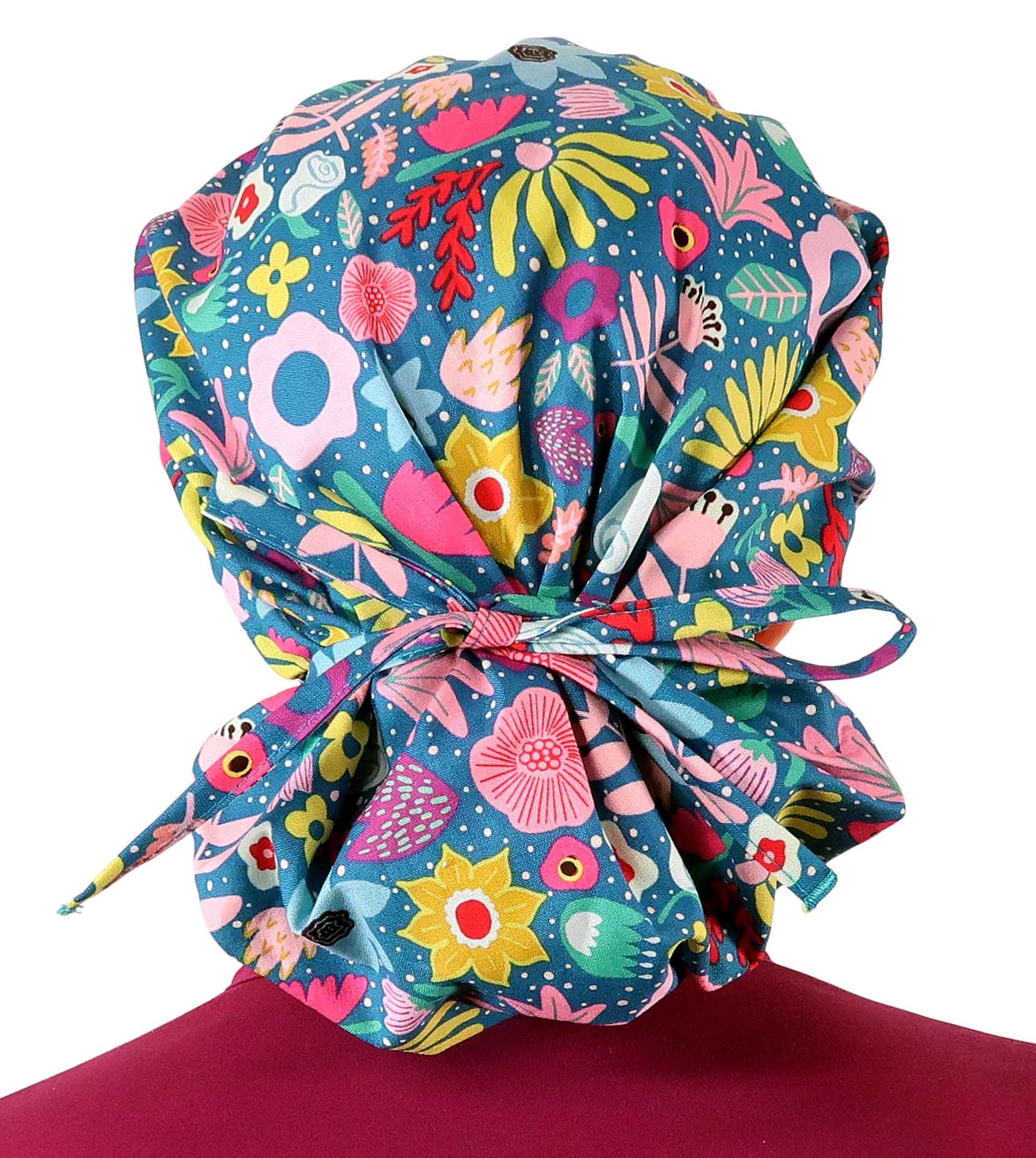 Front Facing View of a Woman Wearing a Bouffant Ponytail Scrub Cap Tied - Floating Flowers Banded Bouffant Ponytail Surgical Scrub Caps Pattern