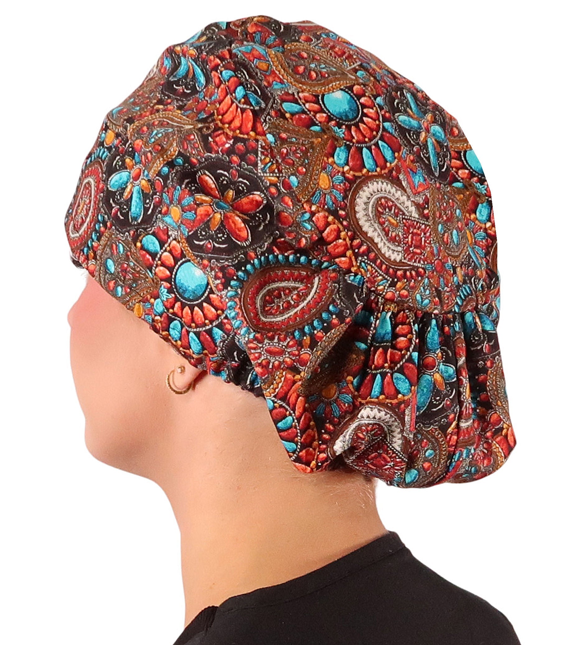 Side facing image of a woman in scrubs wearing a Indian Jewelry Coral Euro Style Riley Comfort Scrub Cap.