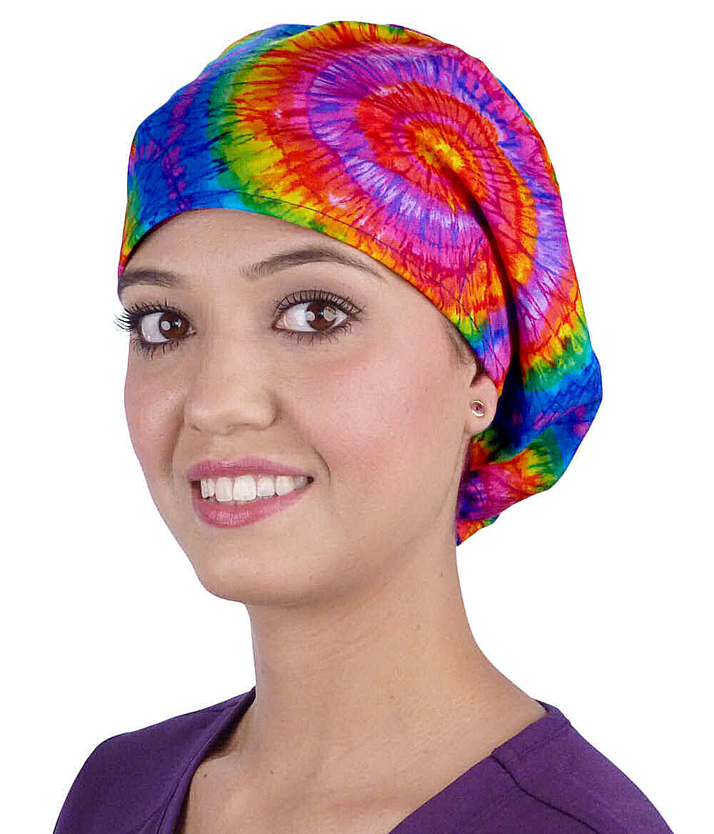 Front facing image of a woman in scrubs wearing a Tie Dye Euro Style Riley Comfort Scrub Cap.
