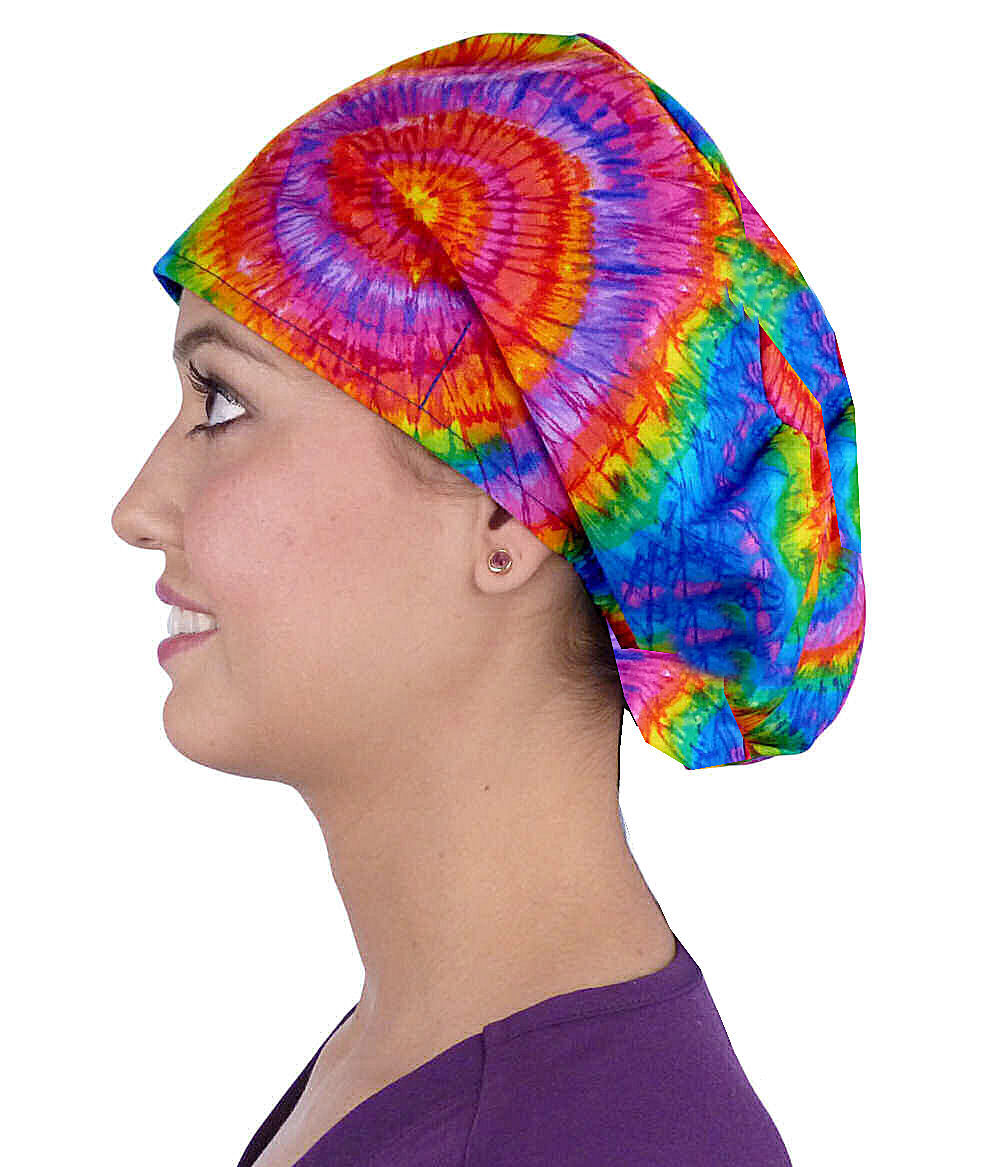 Side facing image of a woman in scrubs wearing a Tie Dye Euro Style Riley Comfort Scrub Cap.