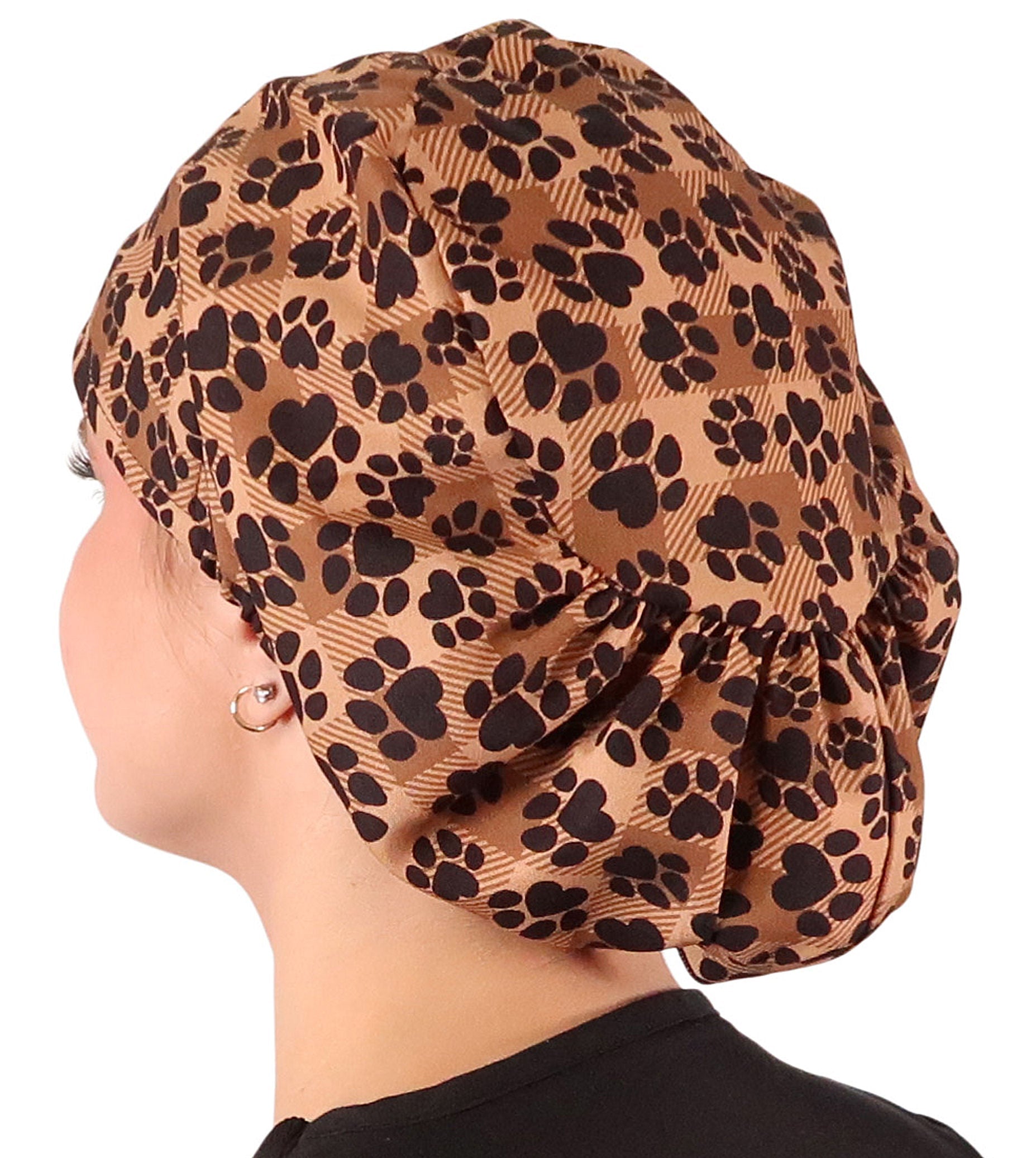 Side facing image of a woman in scrubs wearing a Plentiful Paws on Brown Plaid Euro Style Riley Comfort Scrub Cap.