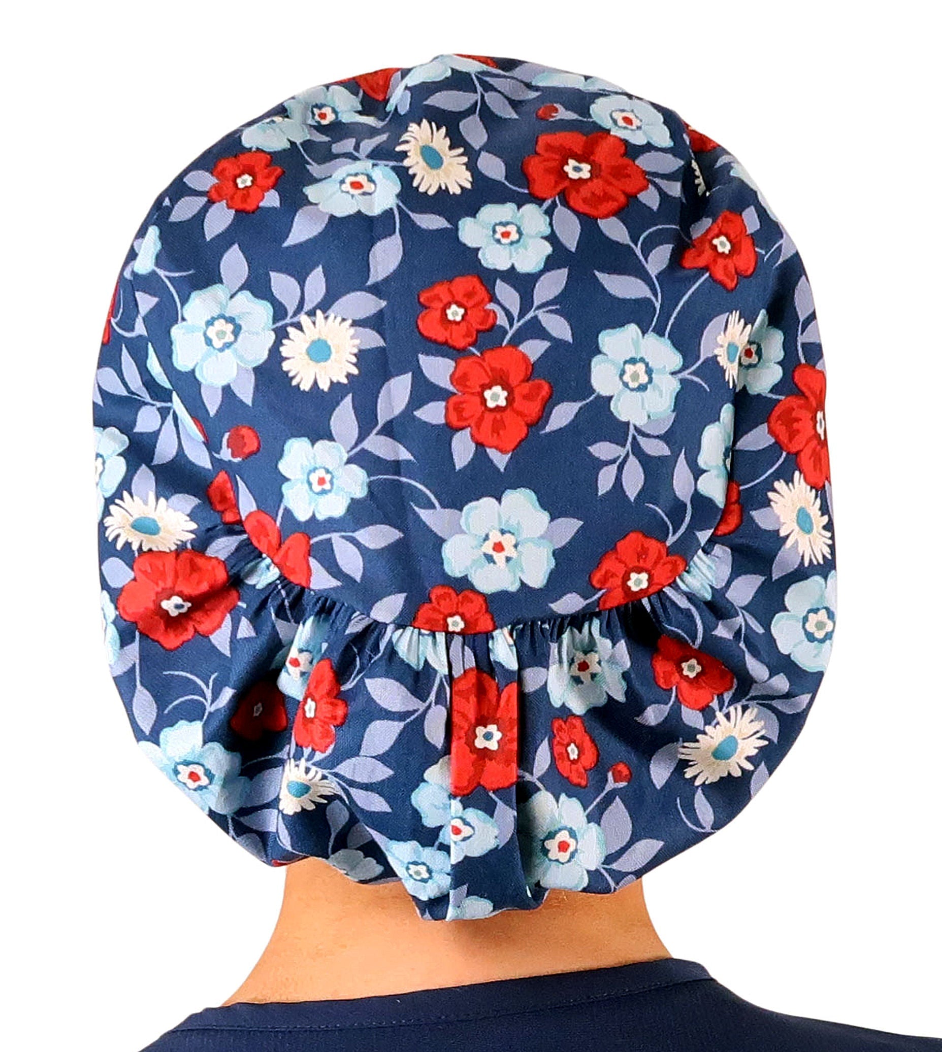 Back facing image of a woman in scrubs wearing a Festive Flowers Euro Style Riley Comfort Scrub Cap.
