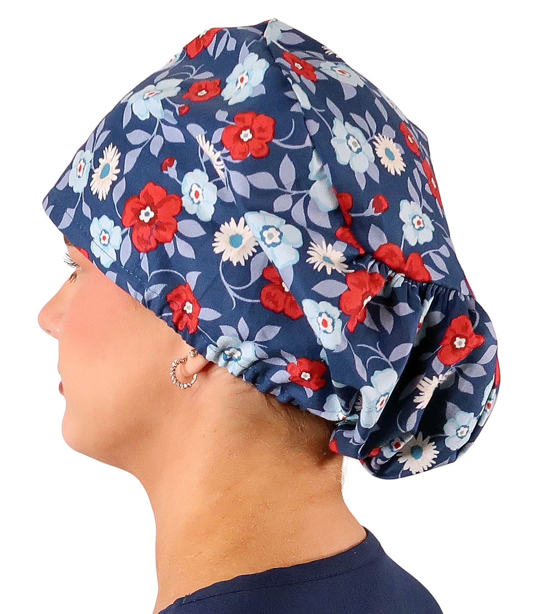 Side facing image of a woman in scrubs wearing a Festive Flowers Euro Style Riley Comfort Scrub Cap.