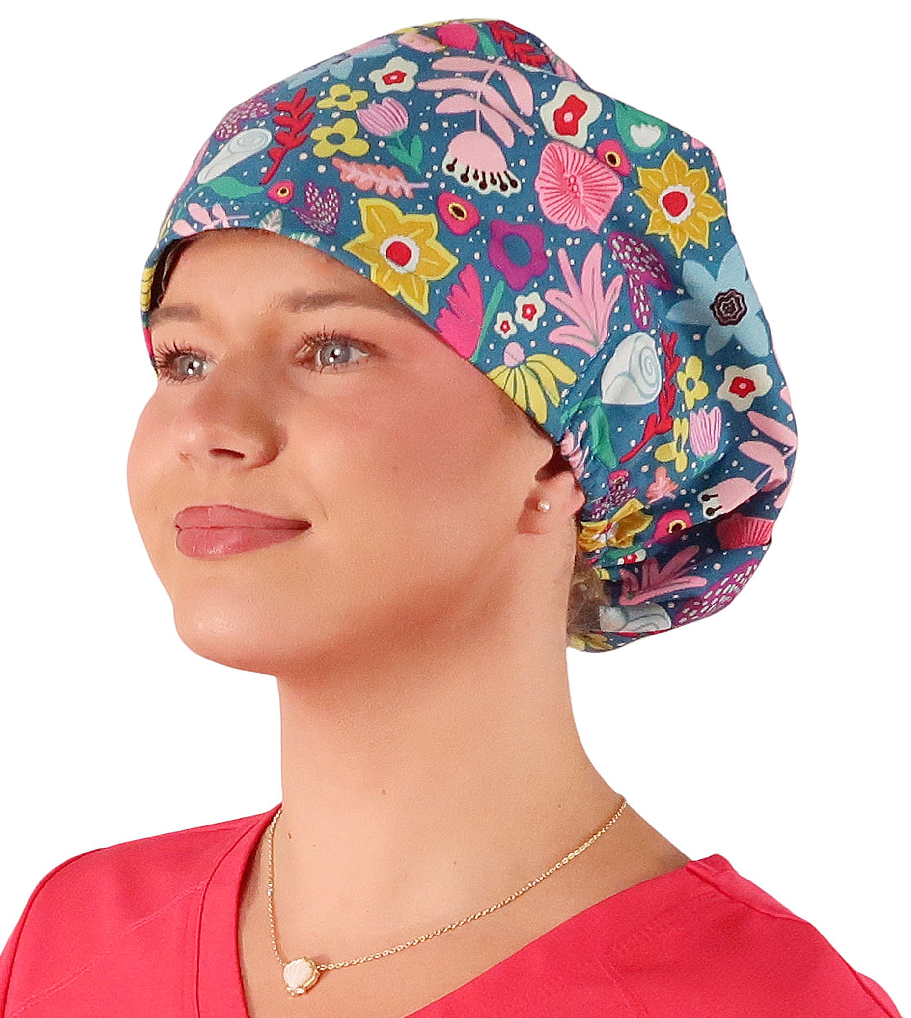 Front facing image of a woman in scrubs wearing a Floating Flowers Euro Style Riley Comfort Scrub Cap.