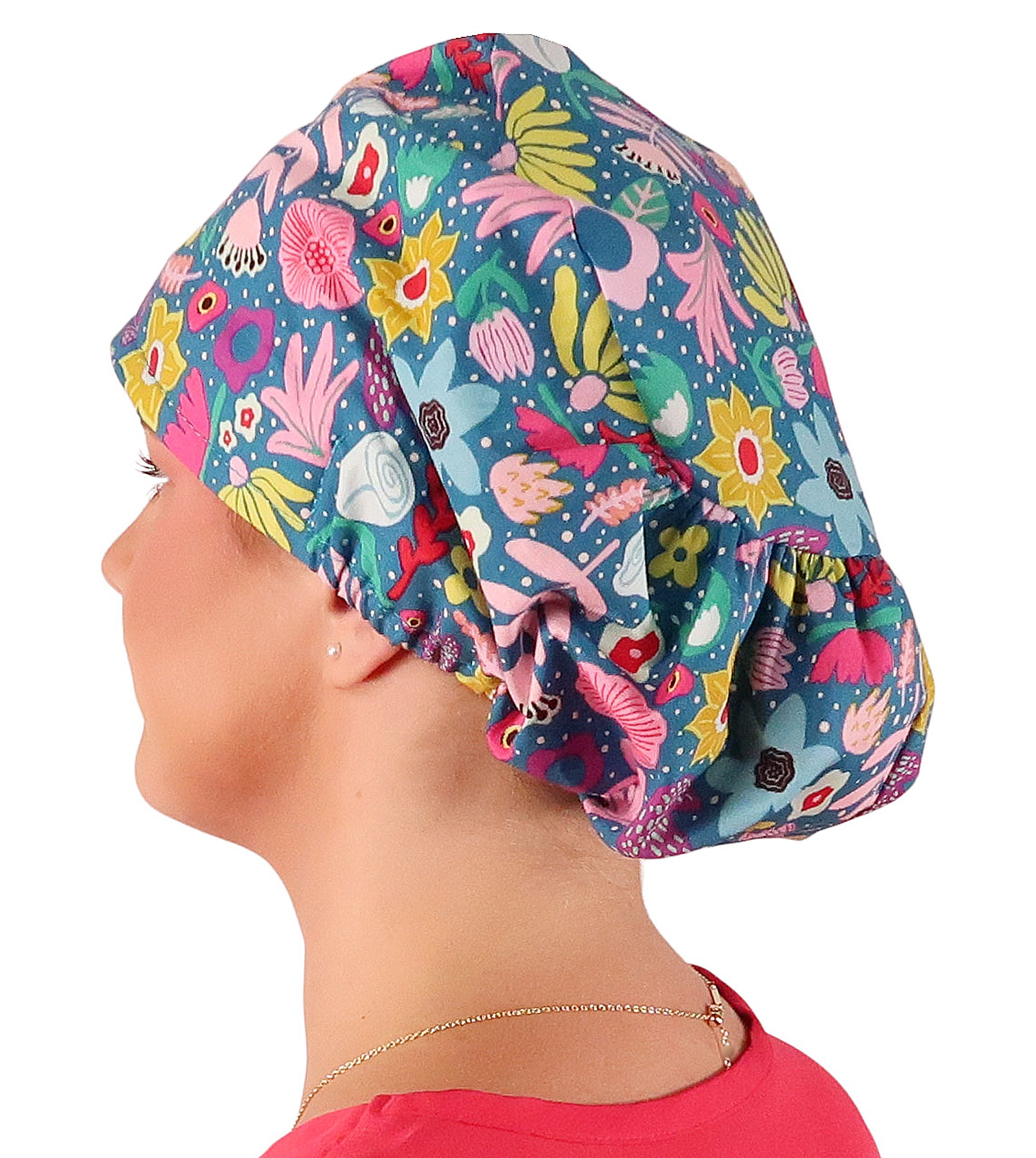 Side facing image of a woman in scrubs wearing a Floating Flowers Euro Style Riley Comfort Scrub Cap.