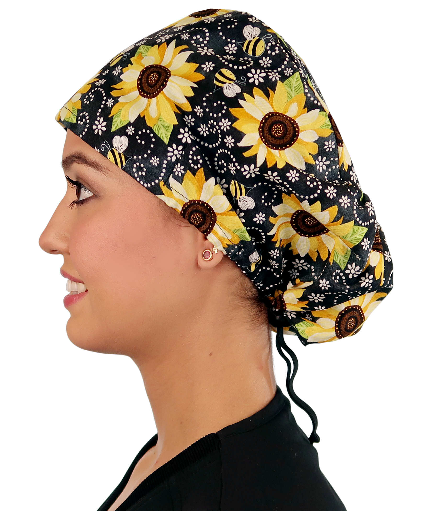 Side facing image of a woman in scrubs wearing a Sunflowers on Black Euro Style Riley Comfort Scrub Cap.