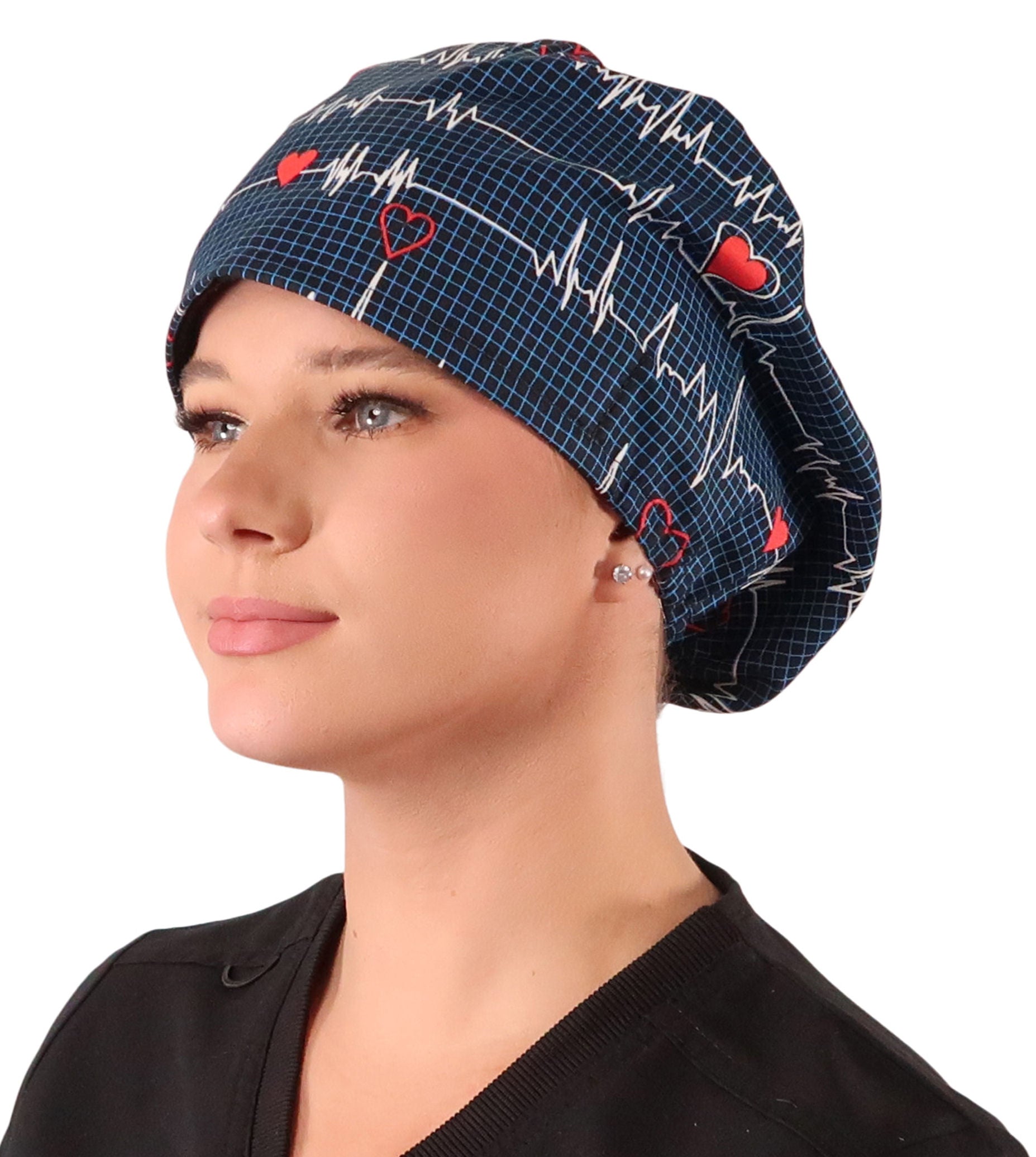 Front facing image of a woman in scrubs wearing a Heartbeats on Navy Euro Style Riley Comfort Scrub Cap.