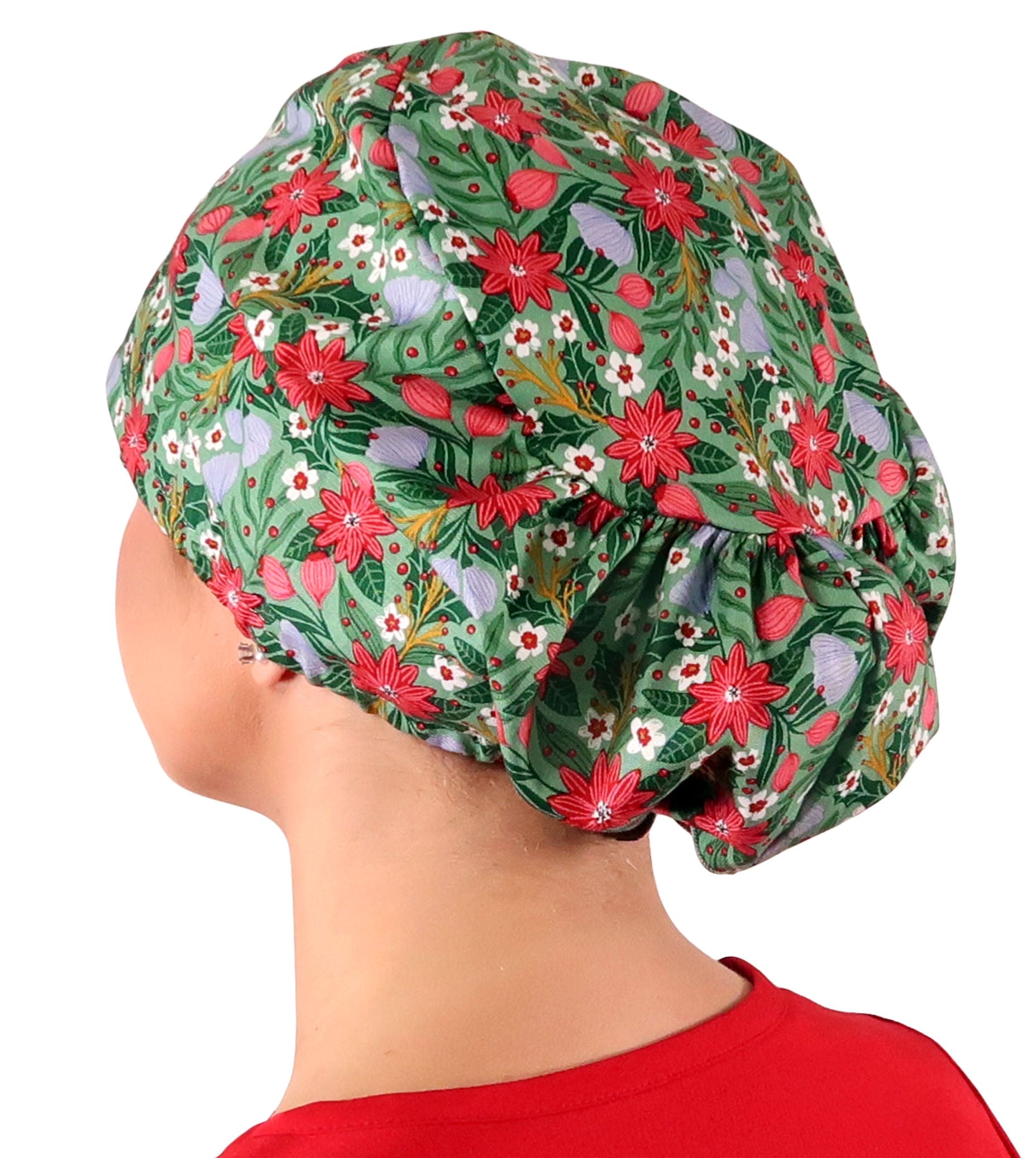 Side facing image of a woman in scrubs wearing a Poinsettia Party Euro Style Riley Comfort Scrub Cap.