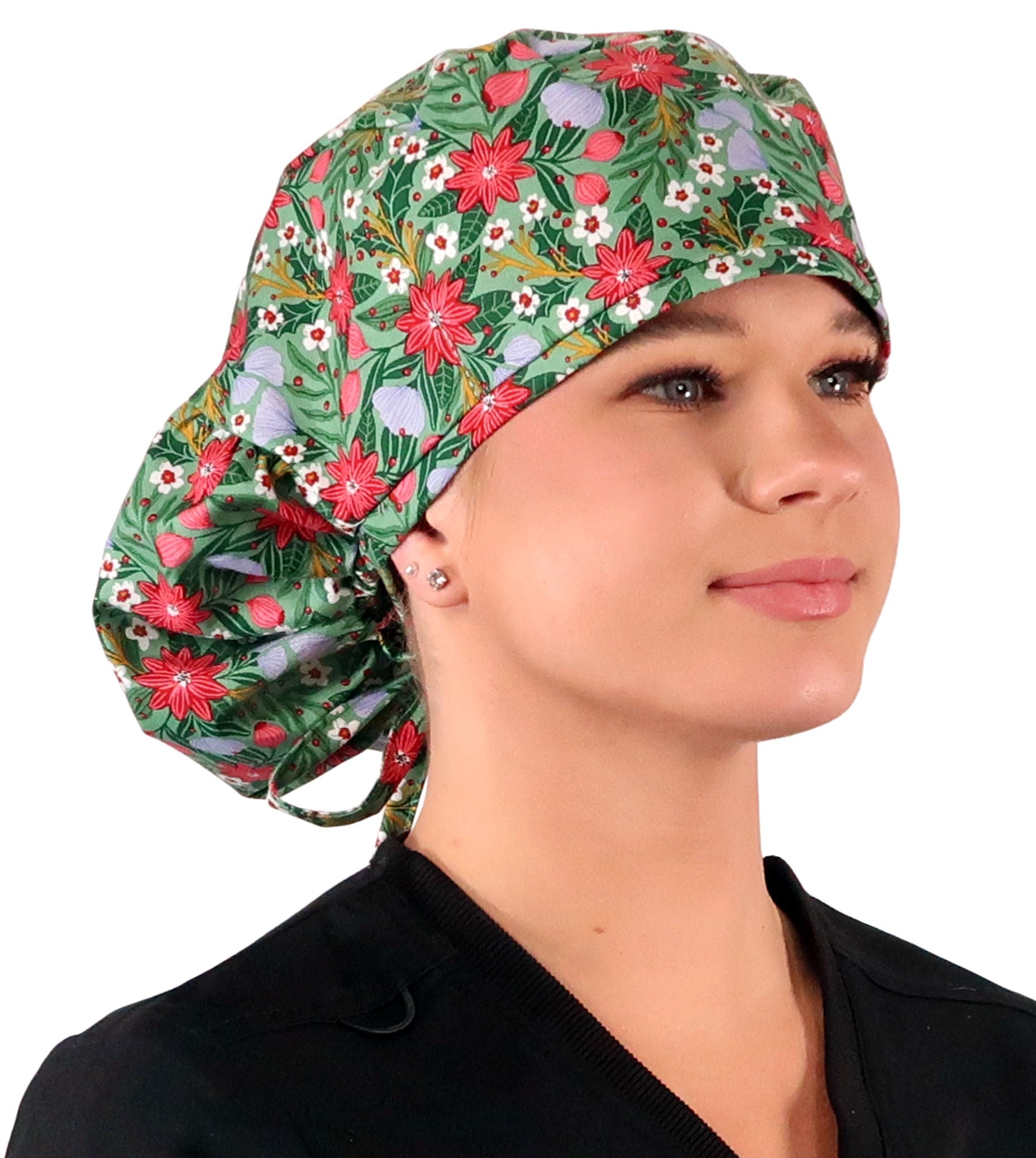 Front facing untied image of a woman in scrubs wearing a Big Hair Ponytail Scrub Cap with a Poinsettia Party pattern. 