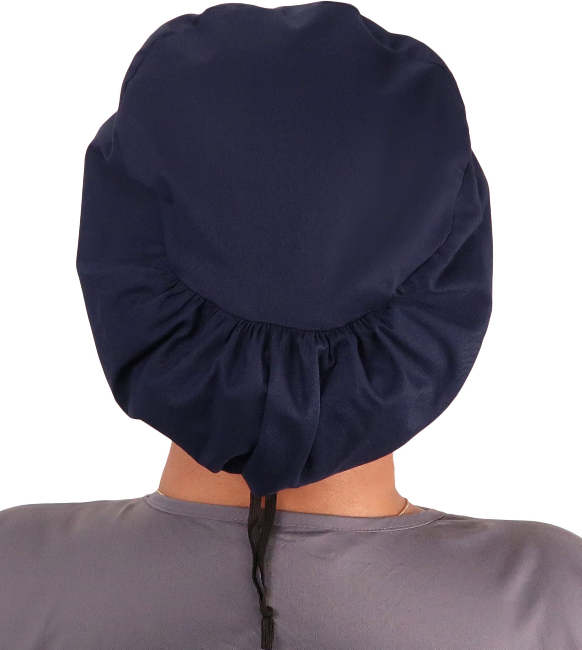 Back facing image of a woman in scrubs wearing a Navy Euro Style Riley Comfort Scrub Cap.