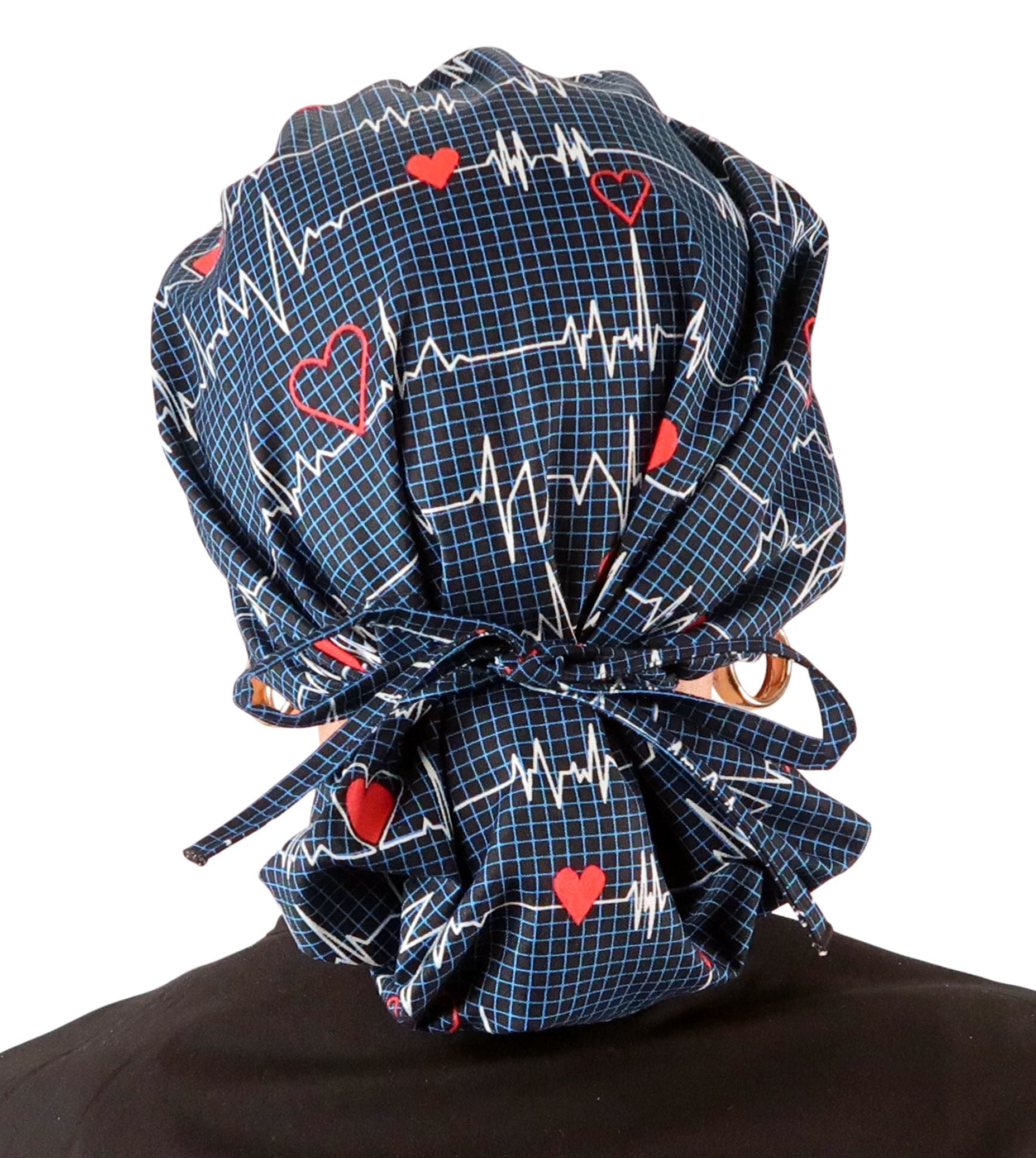 Back Facing Tied View of a Woman Wearing a Tied Back Banded Bouffant Ponytail Surgical Scrub Cap - Heartbeats on Navy Patterned Fabric