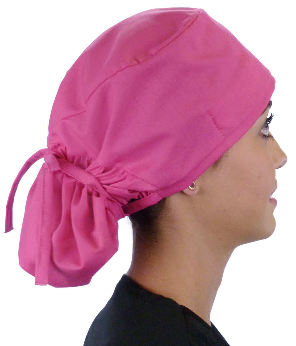 Side facing tied image of a woman in scrubs wearing a Hot Pink Big Hair Ponytail Scrub Cap and hot pink ties to hold the scrub cap in place.