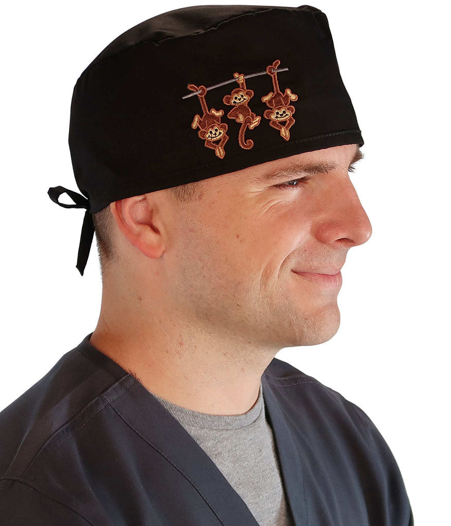 Side Facing View of a Man Wearing a Classic Cotton Surgical Scrub Cap - Black with Three Monkeys Patch.