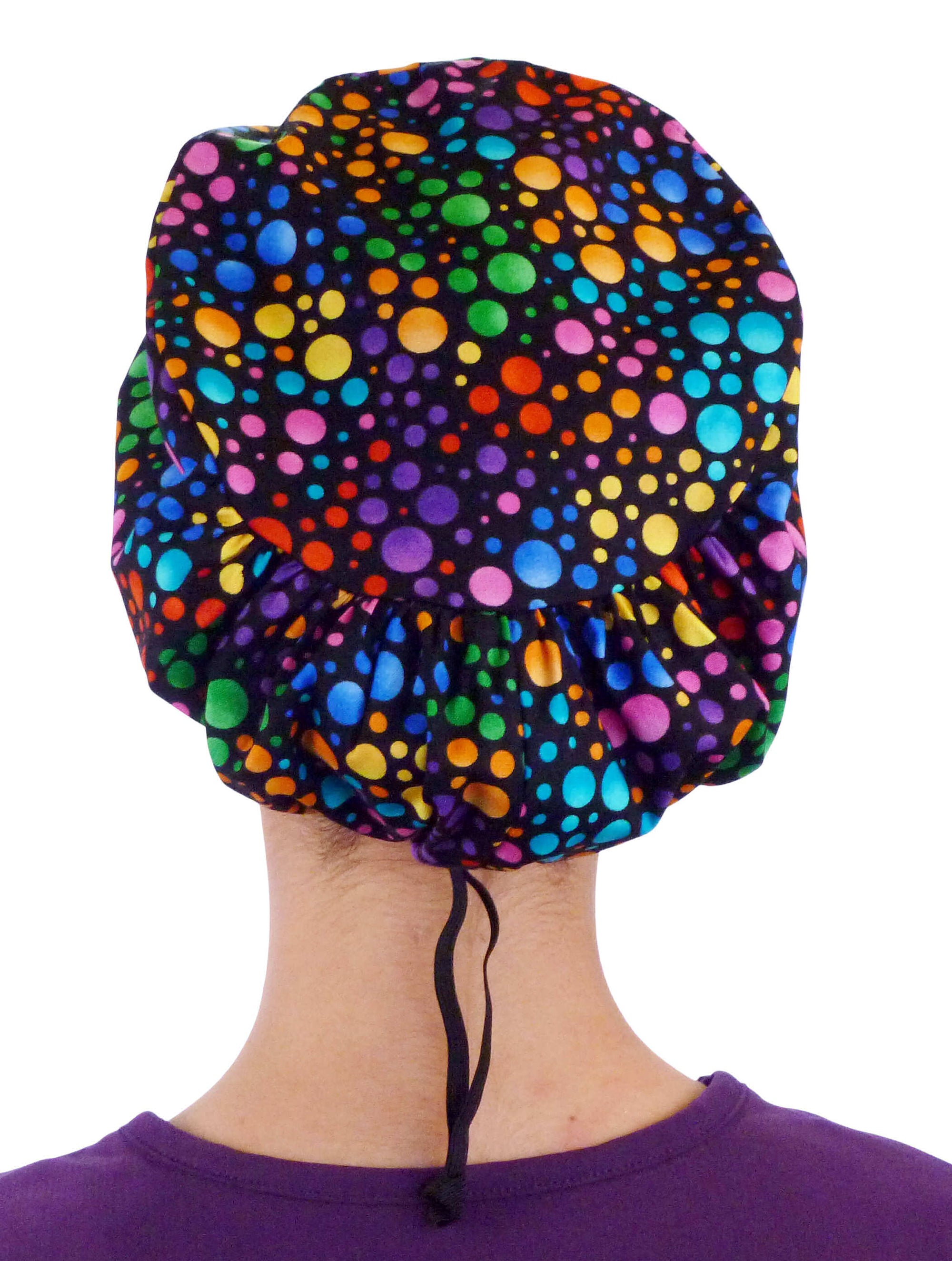 Back facing image of a woman in scrubs wearing a Multi Colored Dots Euro Style Riley Comfort Scrub Cap.