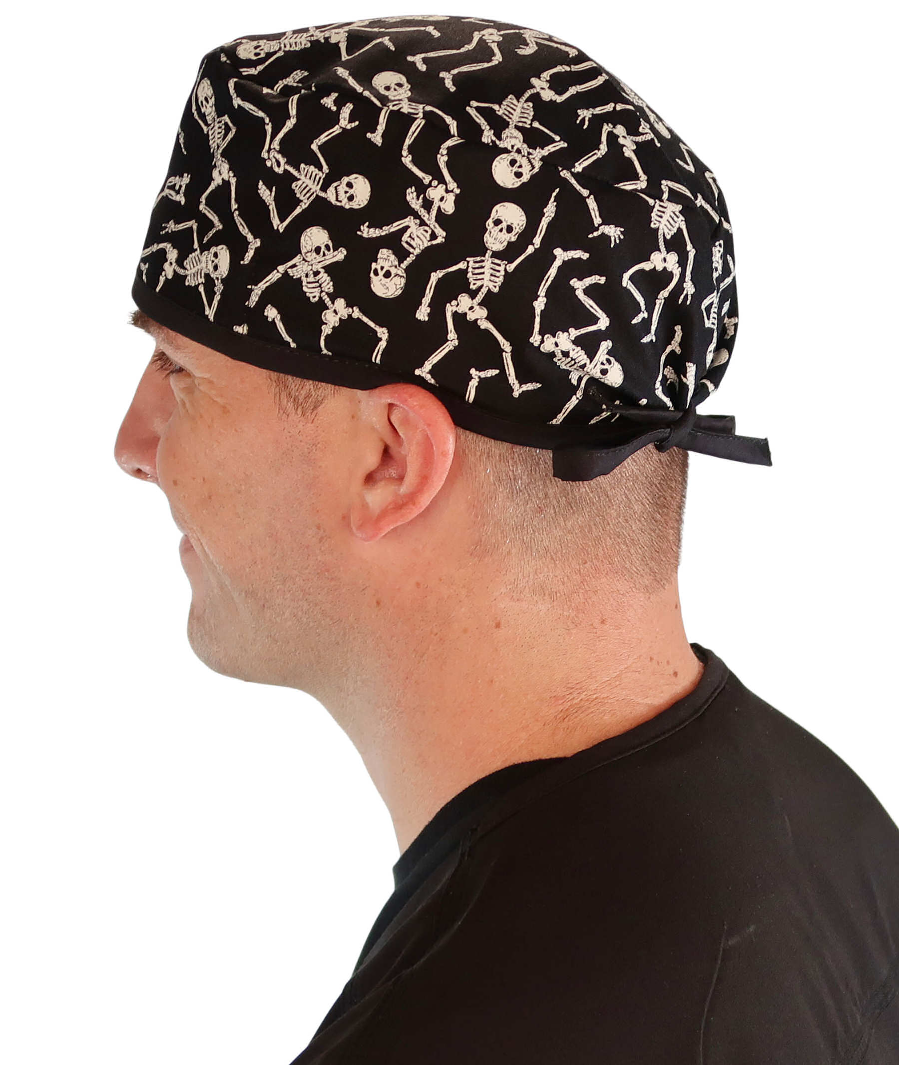 Side Facing View of a Man Wearing a Classic Cotton Surgical Scrub Cap - Dancing Skeletons with Black Ties (Glow In The Dark) Pattern.