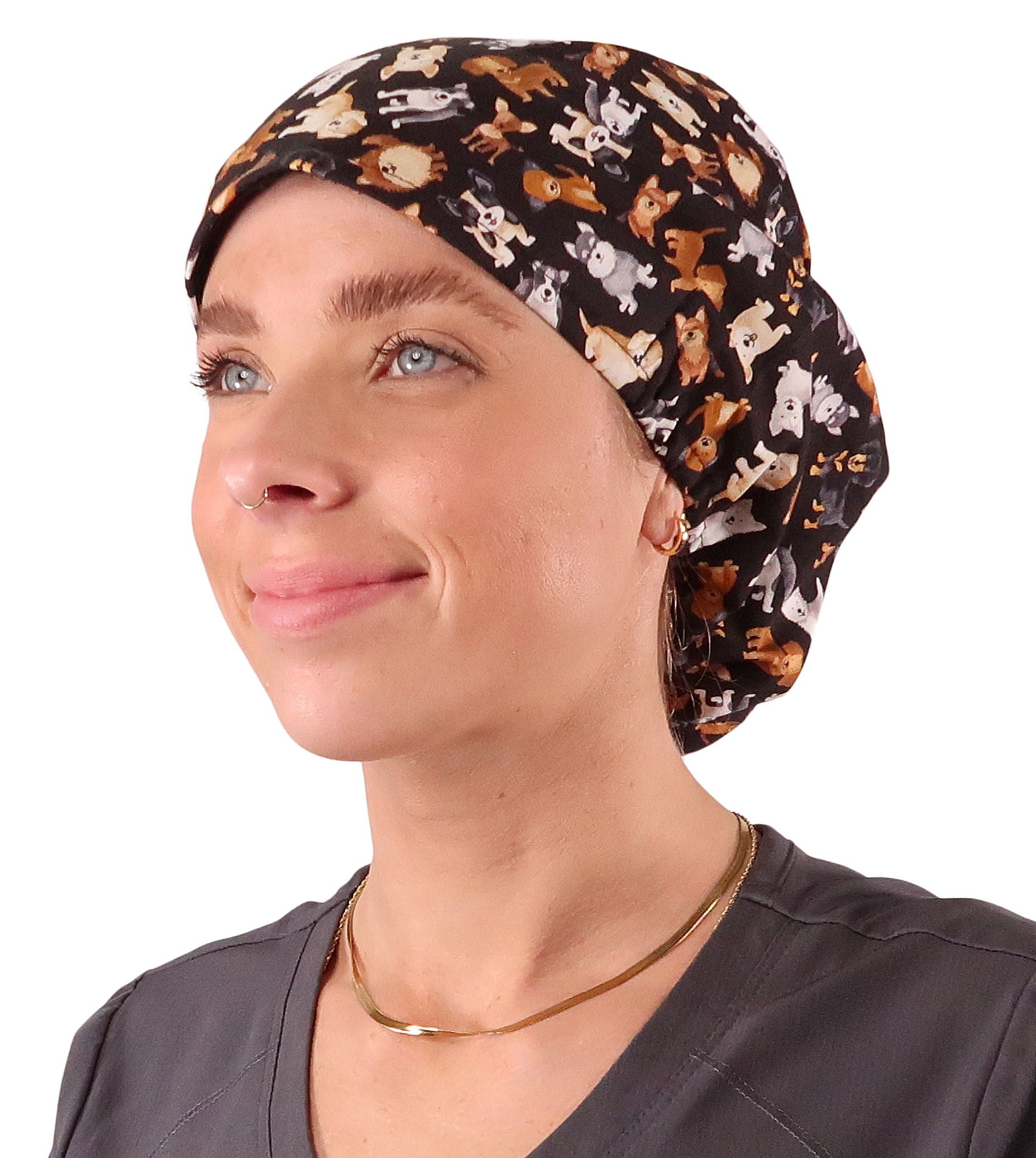 Front facing image of a woman in scrubs wearing a Puppy Parade Dogs Euro Style Riley Comfort Scrub Cap.