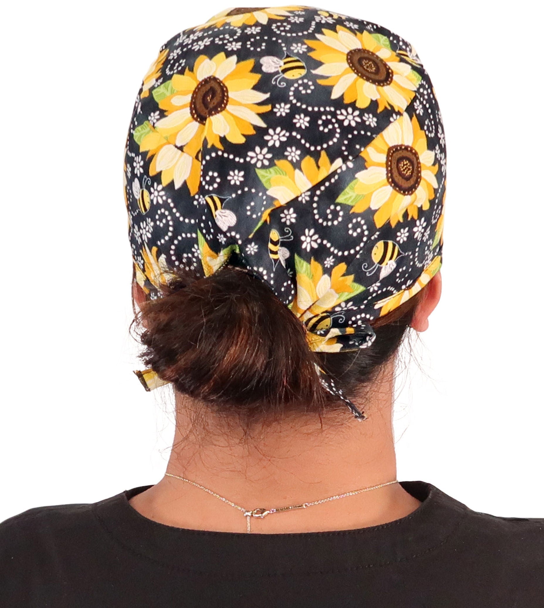 Back facing image of a woman in scrubs wearing a Classic Surgical Scrub Cap in a  Sunflowers on Black pattern.