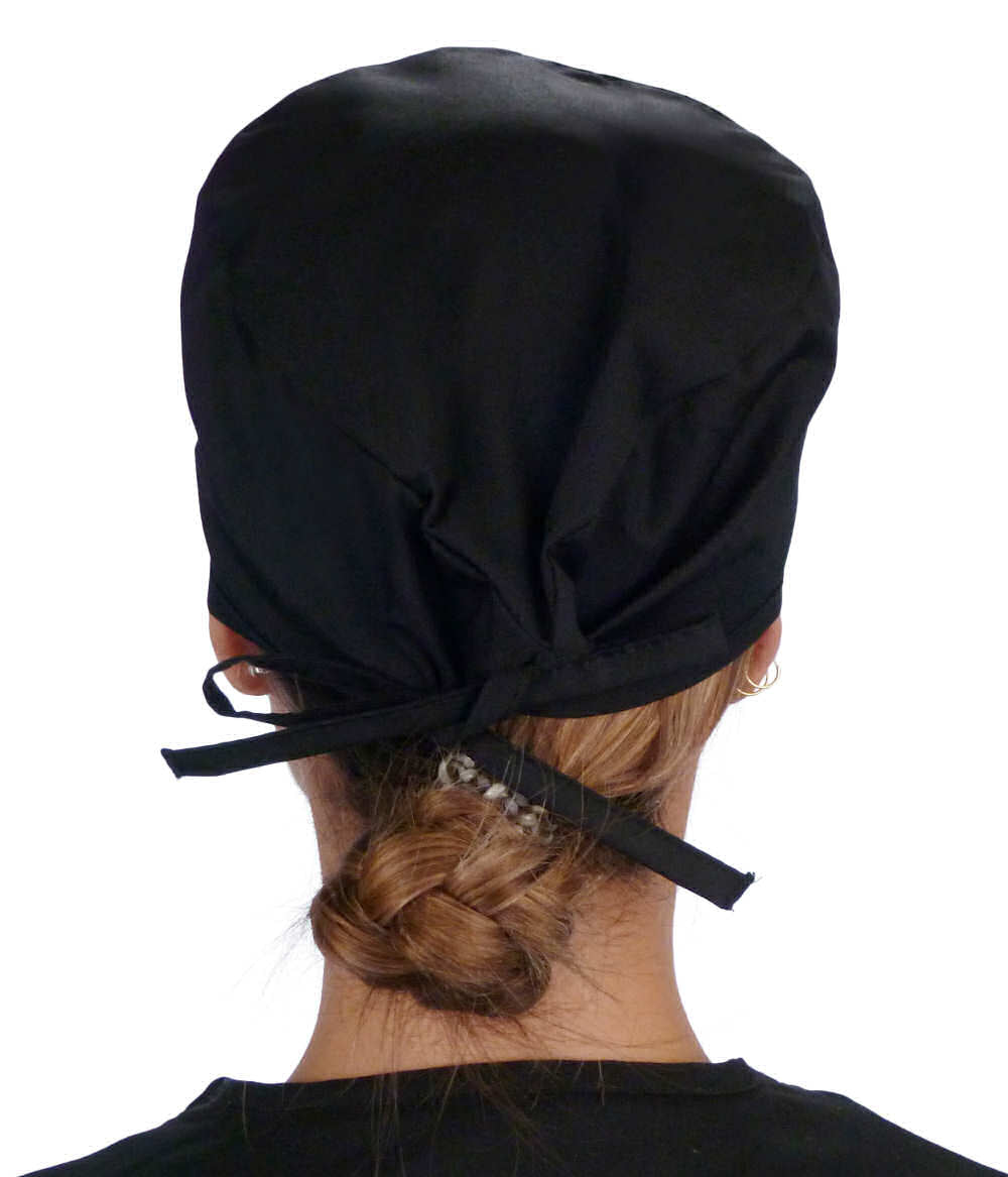 Back facing image of a woman in scrubs wearing a Classic Surgical Scrub Cap in a Bones on Black pattern.