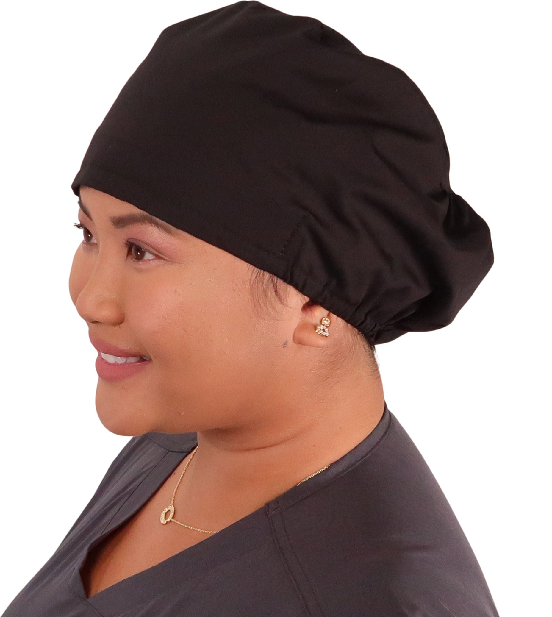Side facing image of a woman in scrubs wearing a Black Euro Style Riley Comfort Scrub Cap.
