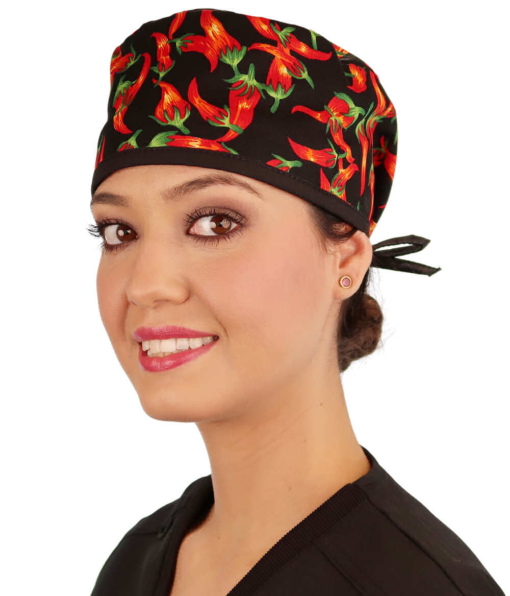 Front facing image of a woman in scrubs wearing a Classic Surgical Scrub Cap in a Mixed Chili Peppers pattern.