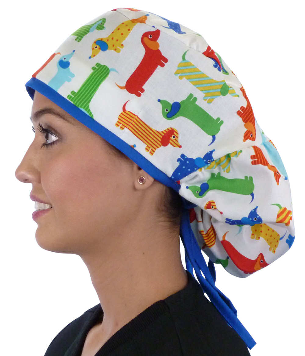 Side facing untied image of a woman in scrubs wearing a Big Hair Ponytail Scrub Cap with a Tossed Wiener Dogs pattern, and royal ties to hold the scrub cap in place.