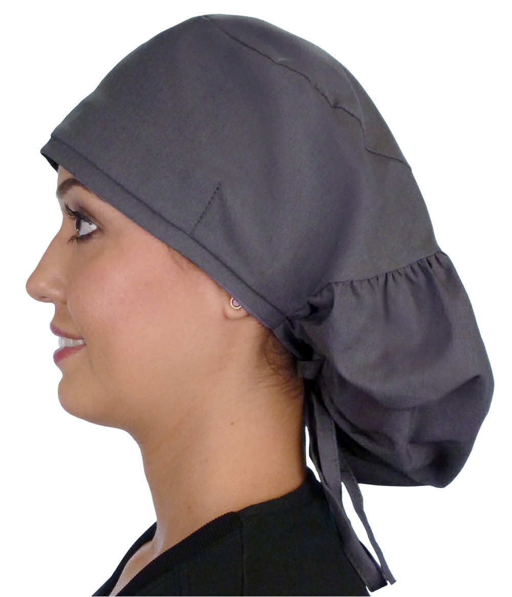 Side facing untied image of a woman in scrubs wearing a Grey Big Hair Ponytail Scrub Cap and grey ties to hold the scrub cap in place.