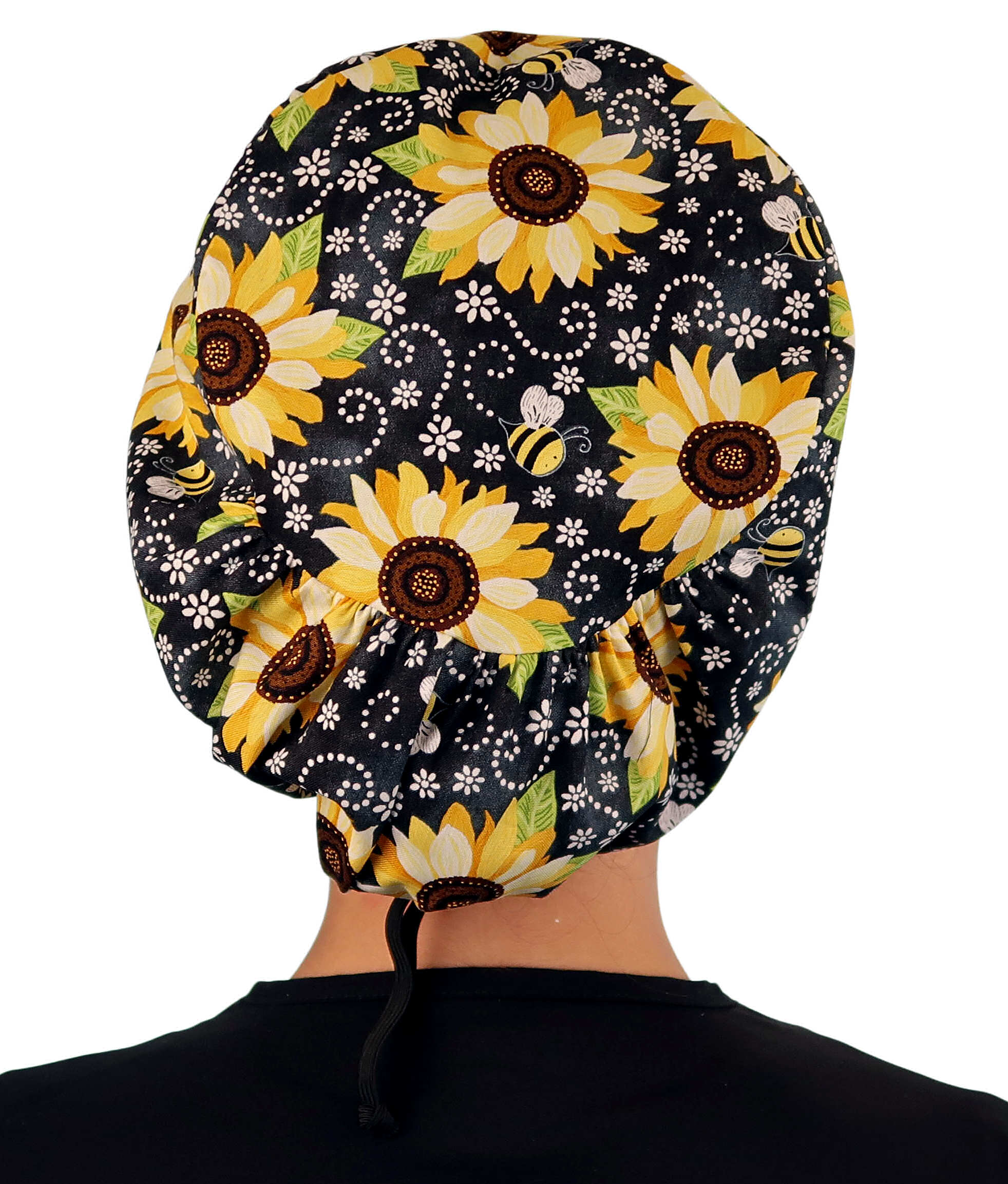 Back facing image of a woman in scrubs wearing a Sunflowers on Black Euro Style Riley Comfort Scrub Cap.