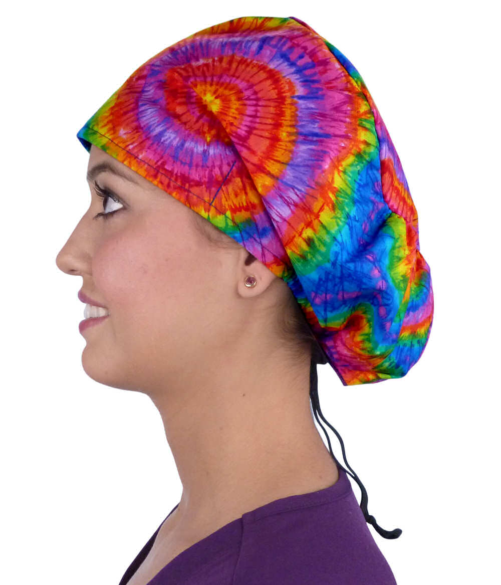 Side facing image of a woman in scrubs wearing a Tie Dye Euro Style Riley Comfort Scrub Cap.