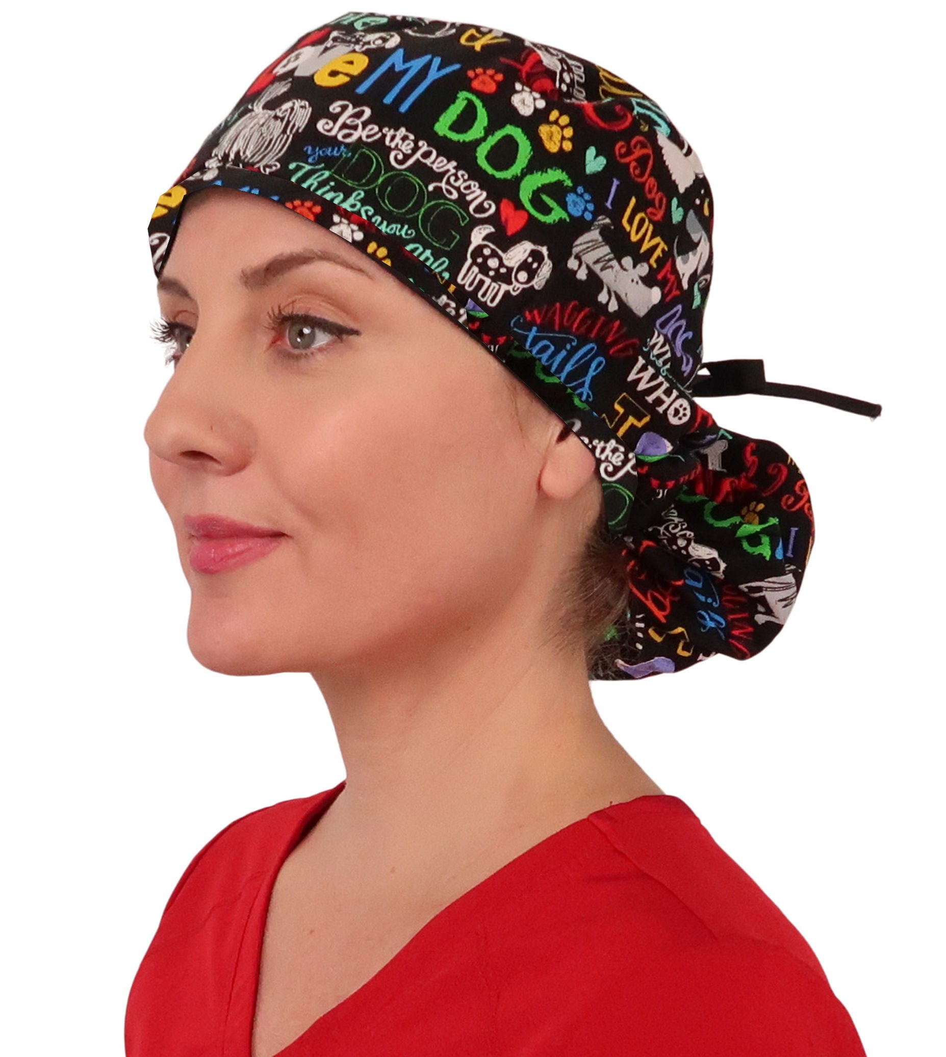 Front facing tied image of a woman in scrubs wearing a Big Hair Ponytail Scrub Cap with a I Love My Dog pattern, and black ties to hold the scrub cap in place.