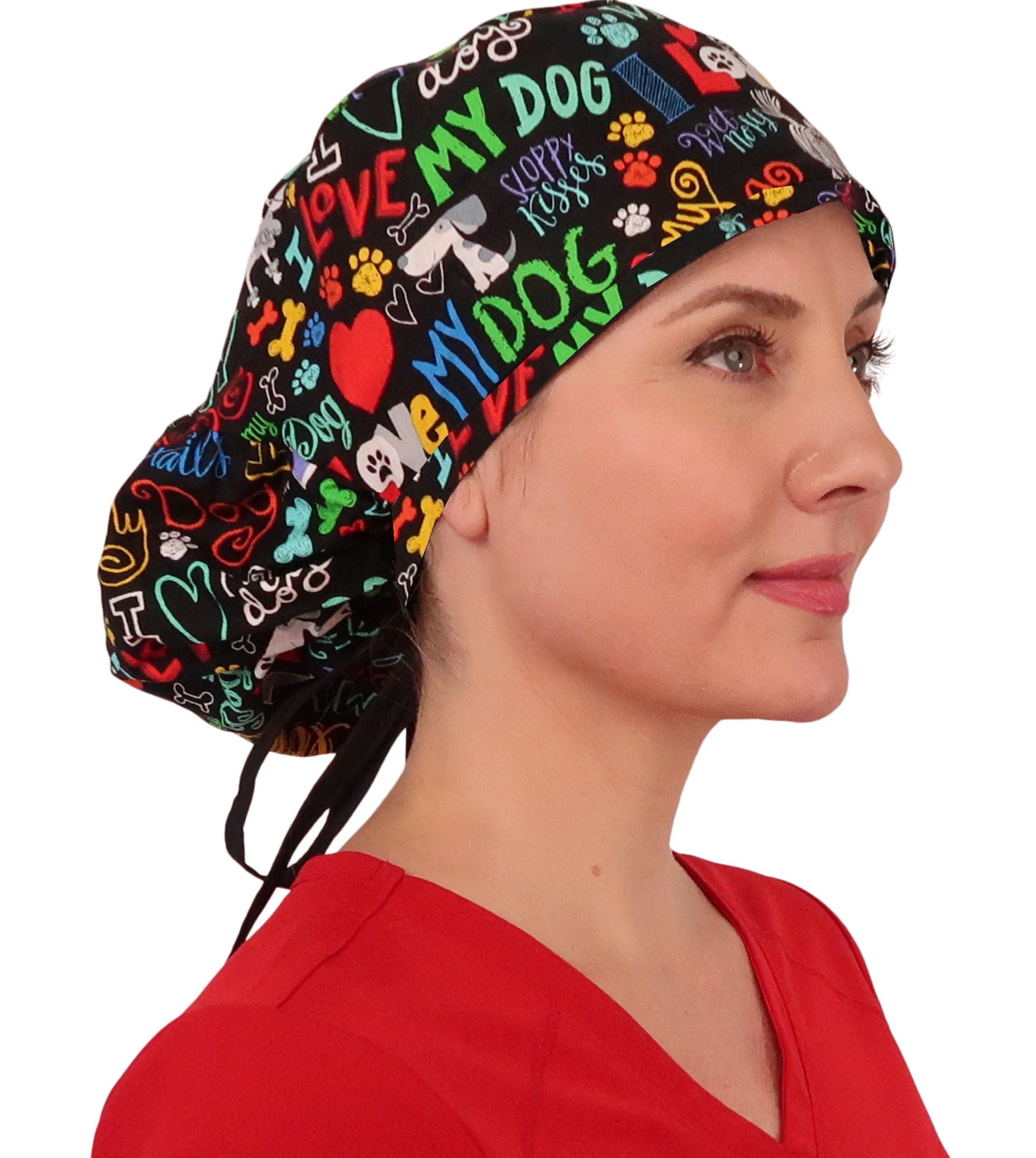 Side facing untied image of a woman in scrubs wearing a Big Hair Ponytail Scrub Cap with a I Love My Dog pattern, and black ties to hold the scrub cap in place