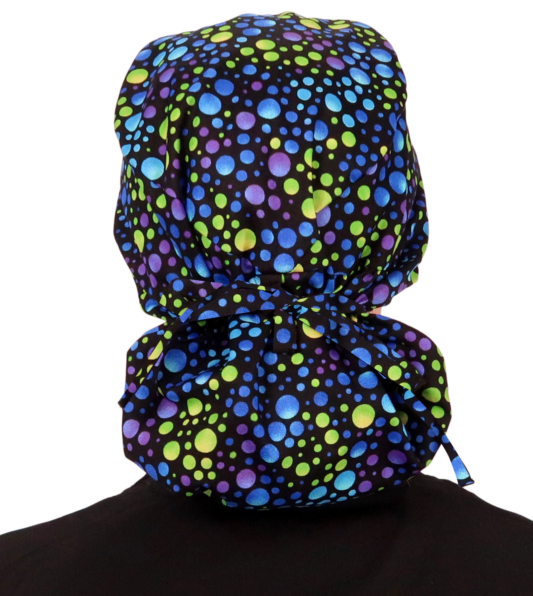 Back facing tied image of a woman in scrubs wearing a Blue, Green and Purple Big Hair Ponytail Scrub Cap.