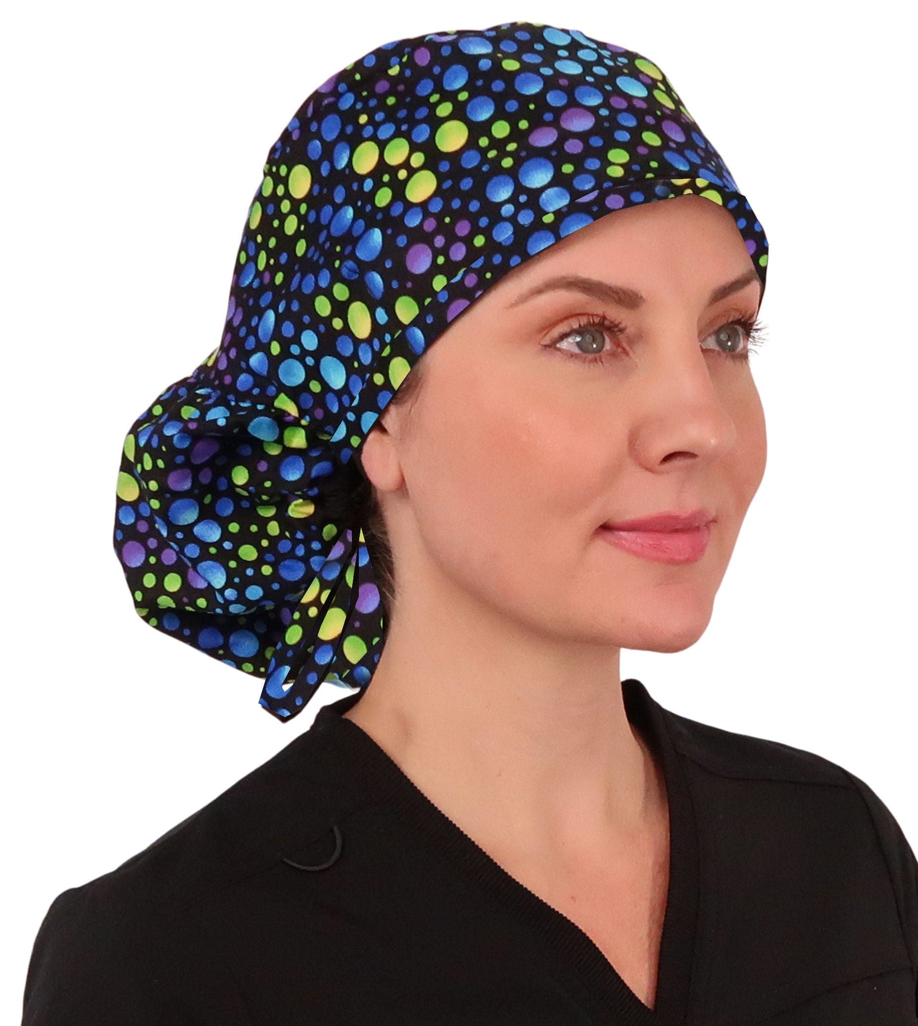 Front facing untied image of a woman in scrubs wearing a Blue, Green and Purple Big Hair Ponytail Scrub Cap.