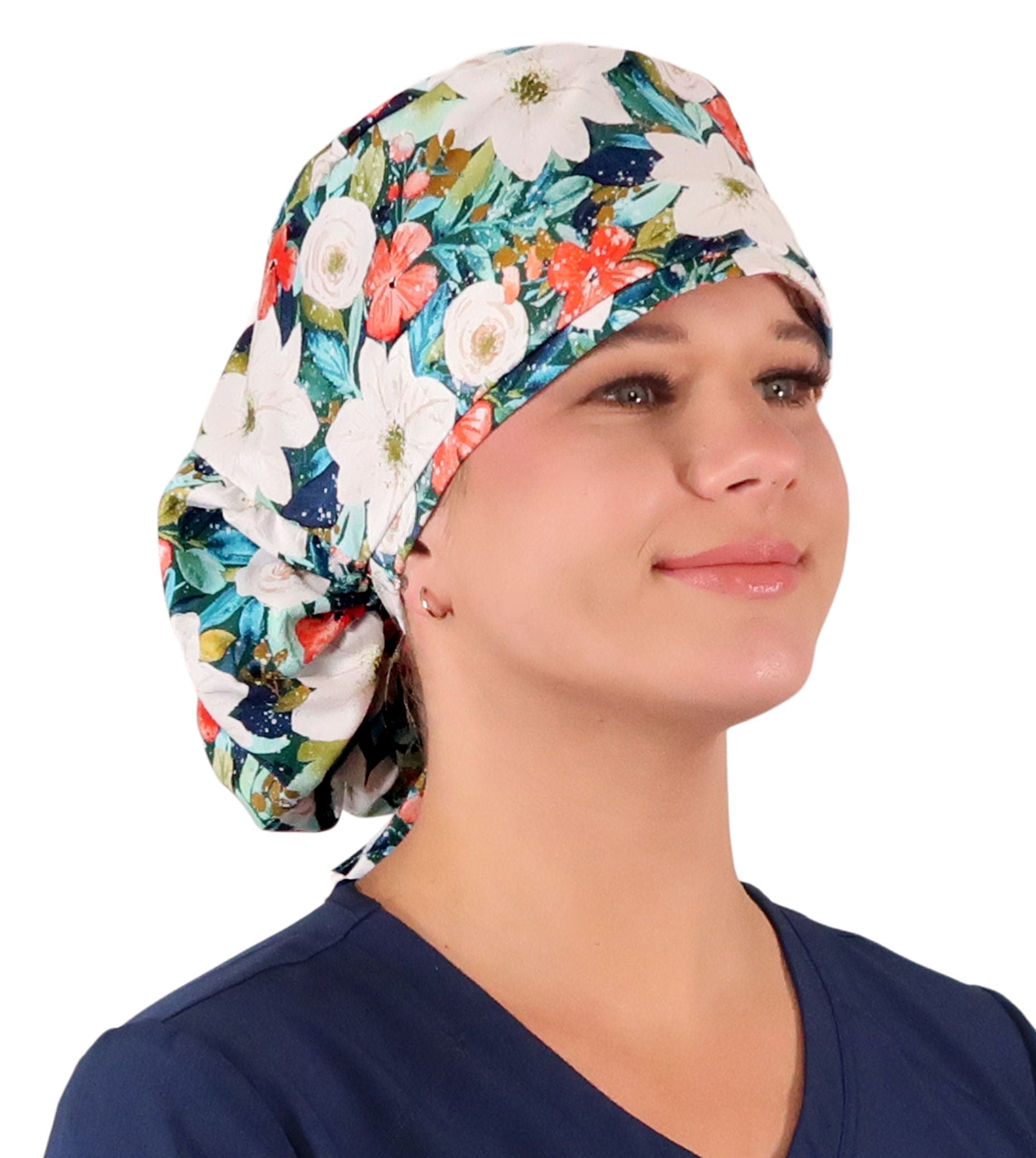 Front facing untied image of a woman in scrubs wearing a Big Hair Ponytail Scrub Cap with a Lush Winter Foliage pattern.