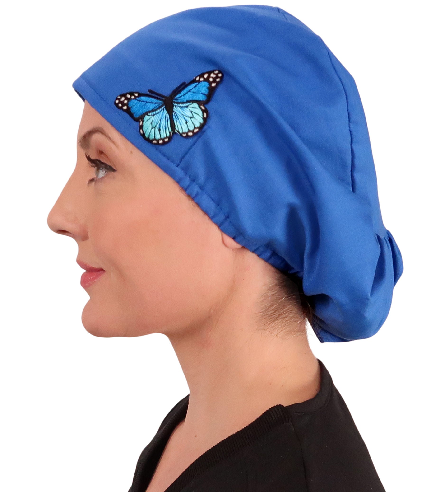 Side facing image of a woman in scrubs wearing a Blue Butterfly Patch on Royal Euro Style Riley Comfort Scrub Cap.