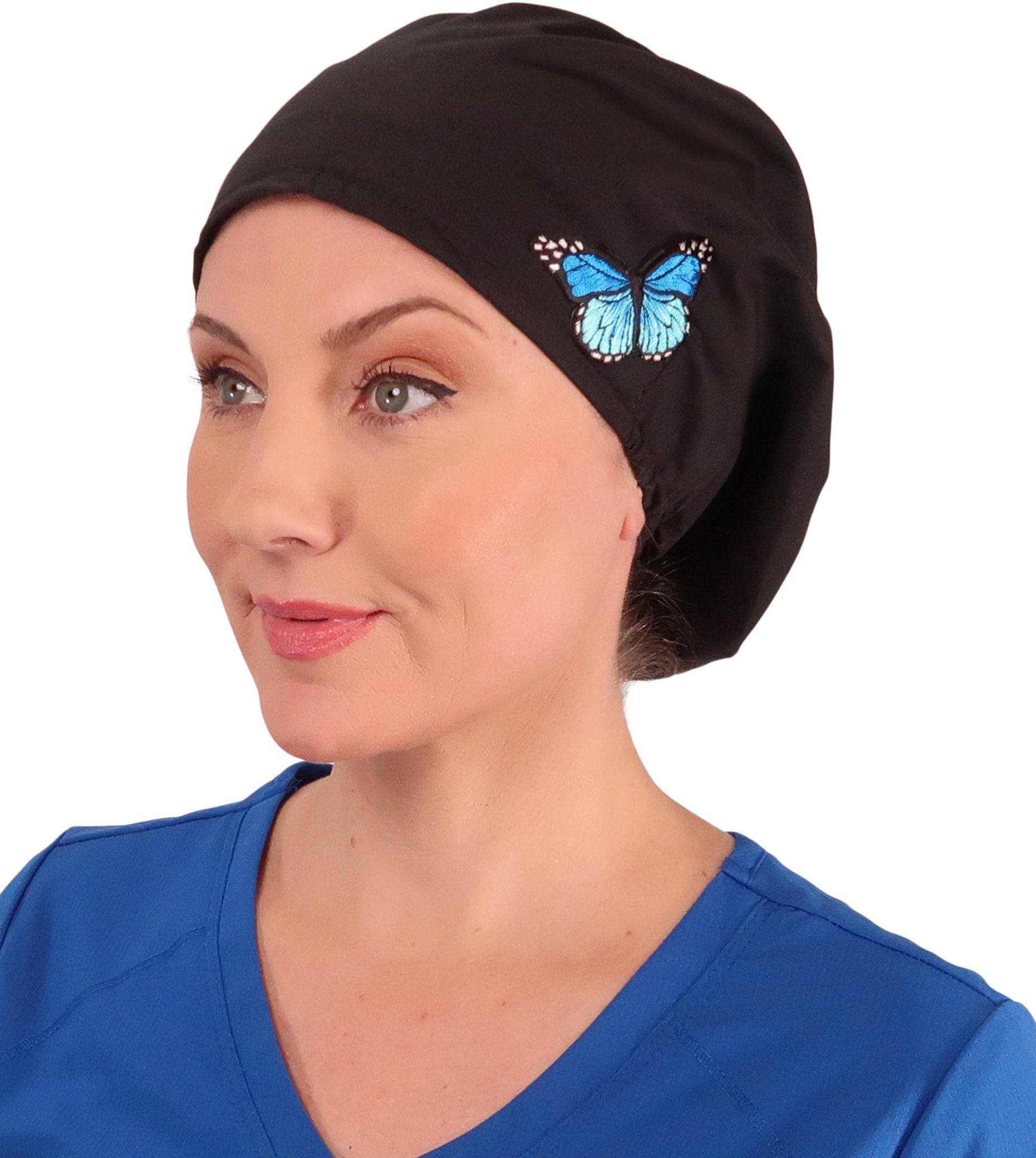 Front facing image of a woman in scrubs wearing a Blue Butterfly Patch on Black Euro Style Riley Comfort Scrub Cap.