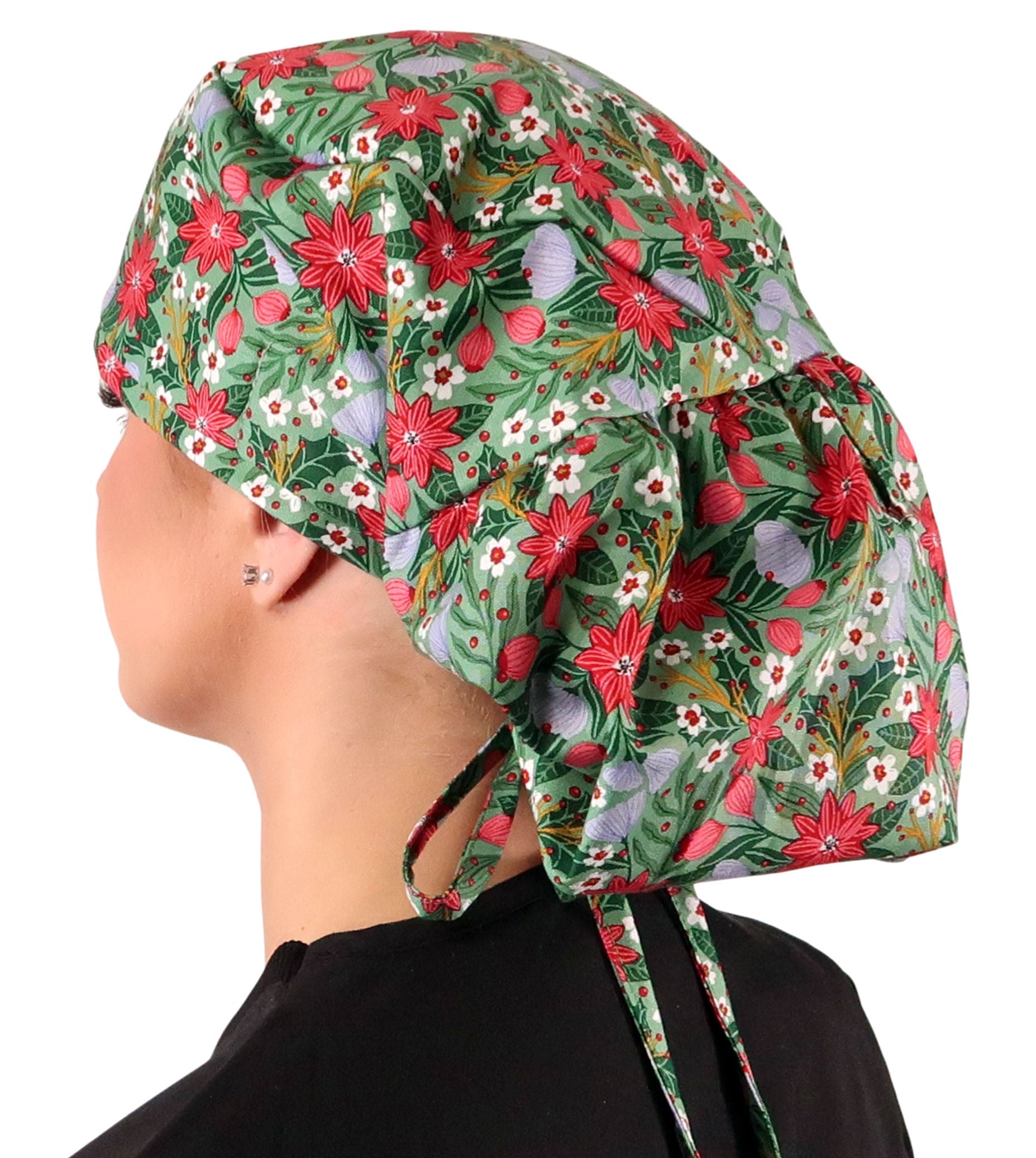 Side facing untied image of a woman in scrubs wearing a Big Hair Ponytail Scrub Cap with a Poinsettia Party pattern. 