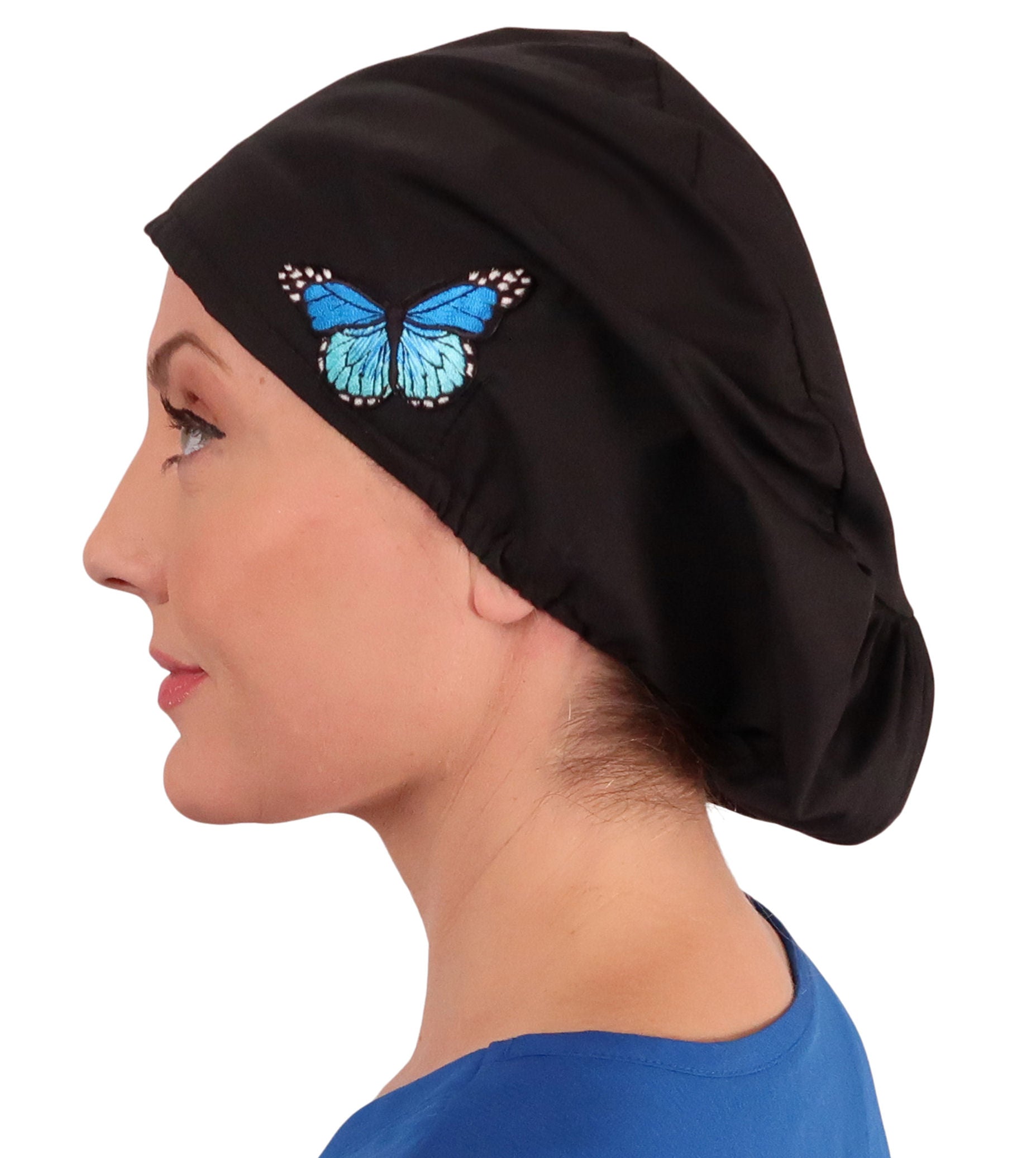 Side facing image of a woman in scrubs wearing a Blue Butterfly Patch on Black Euro Style Riley Comfort Scrub Cap.