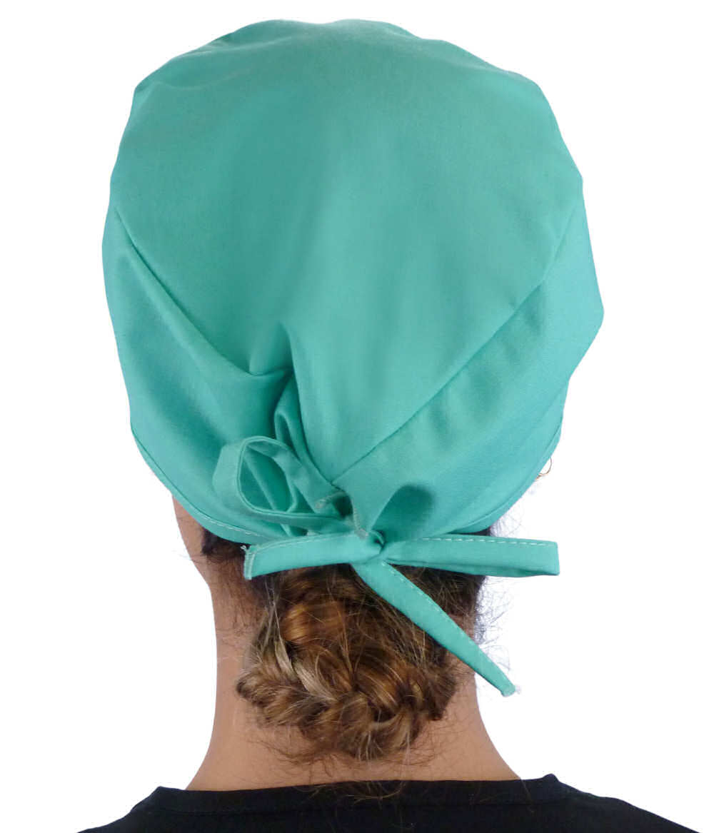 Back facing image of a woman in scrubs wearing a Classic Surgical Scrub Cap in Scrub Green.