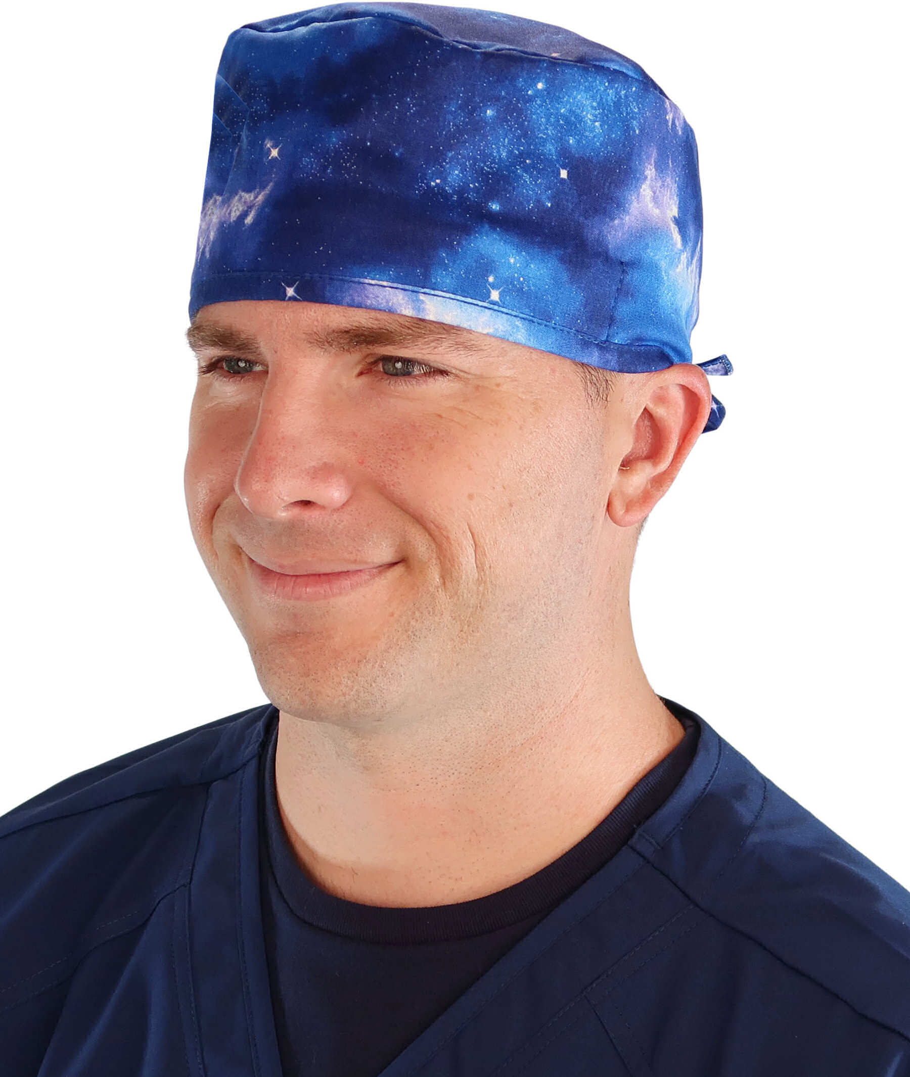 Front facing image of a man in scrubs wearing a Classic Surgical Scrub Cap with a Starry Sky pattern.