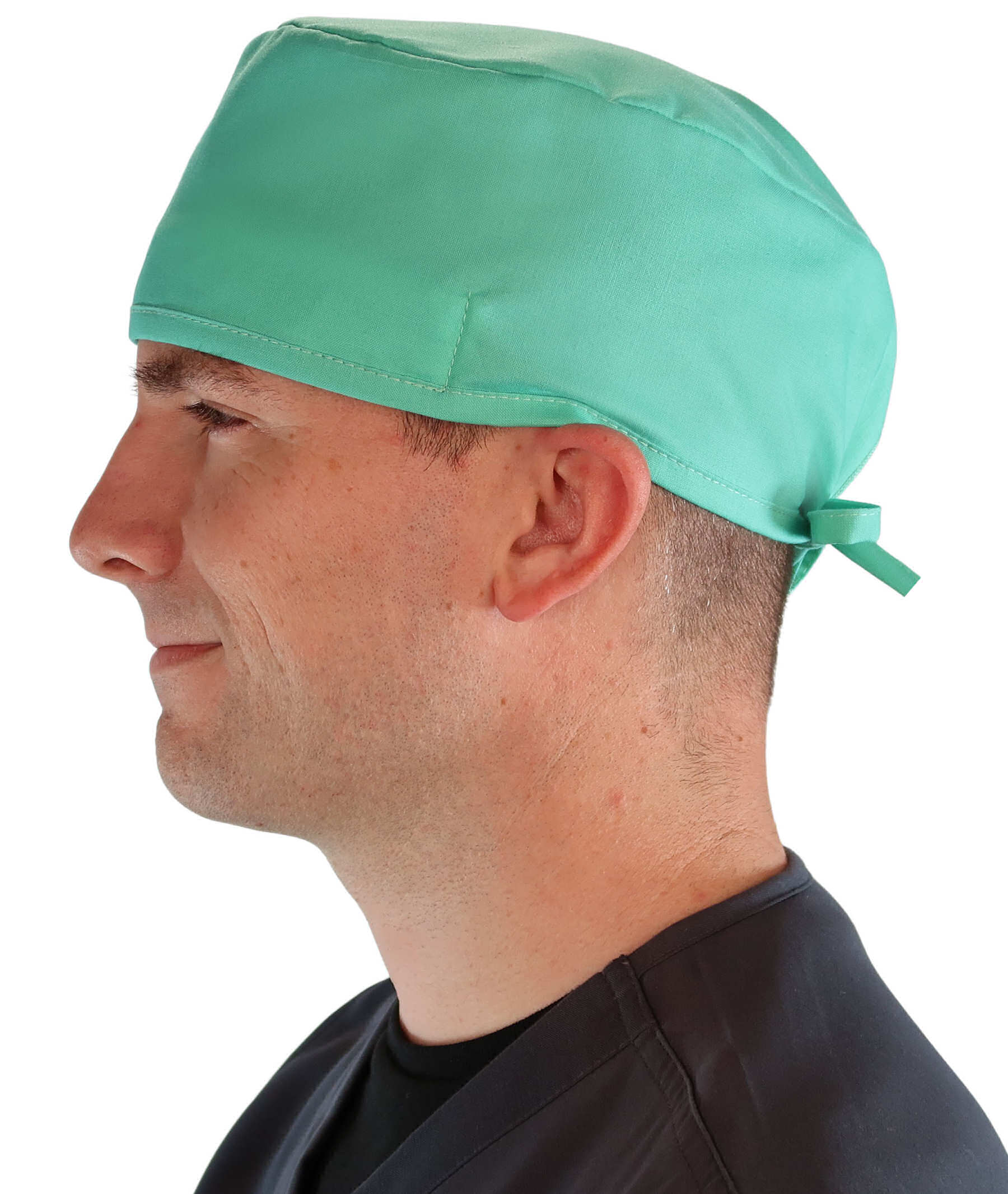 Side facing image of a man in scrubs wearing a Classic Surgical Scrub Cap in Scrub Green.