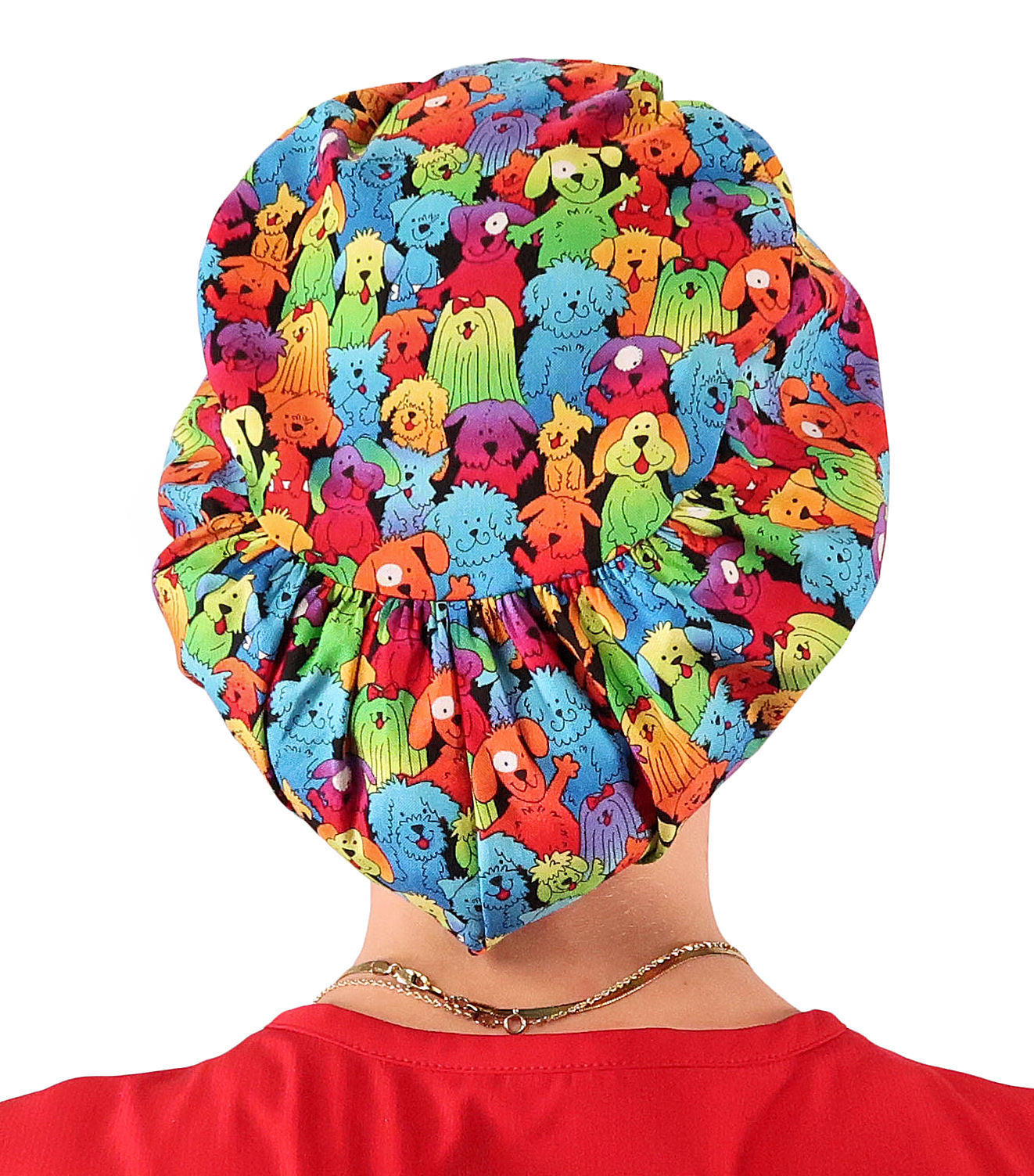 Back facing image of a woman in scrubs wearing a Prismatic Pooch Party Euro Style Riley Comfort Scrub Cap.