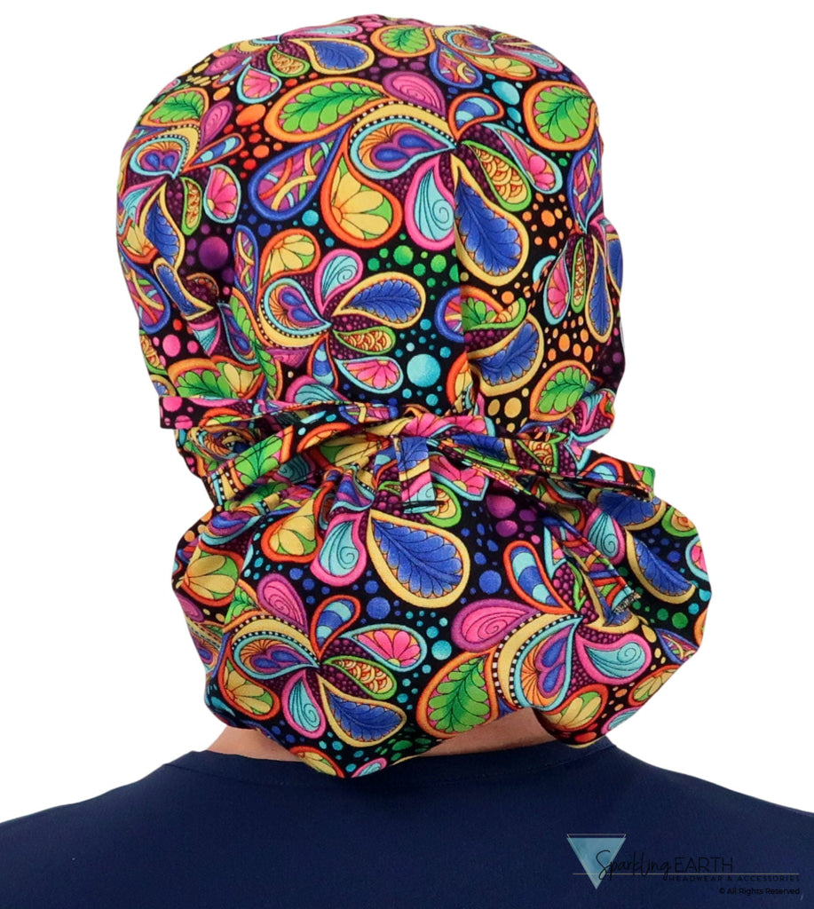 Back facing tied image of a woman in scrubs wearing a Big Hair Ponytail Scrub Cap with a Bright Flower Paisley pattern