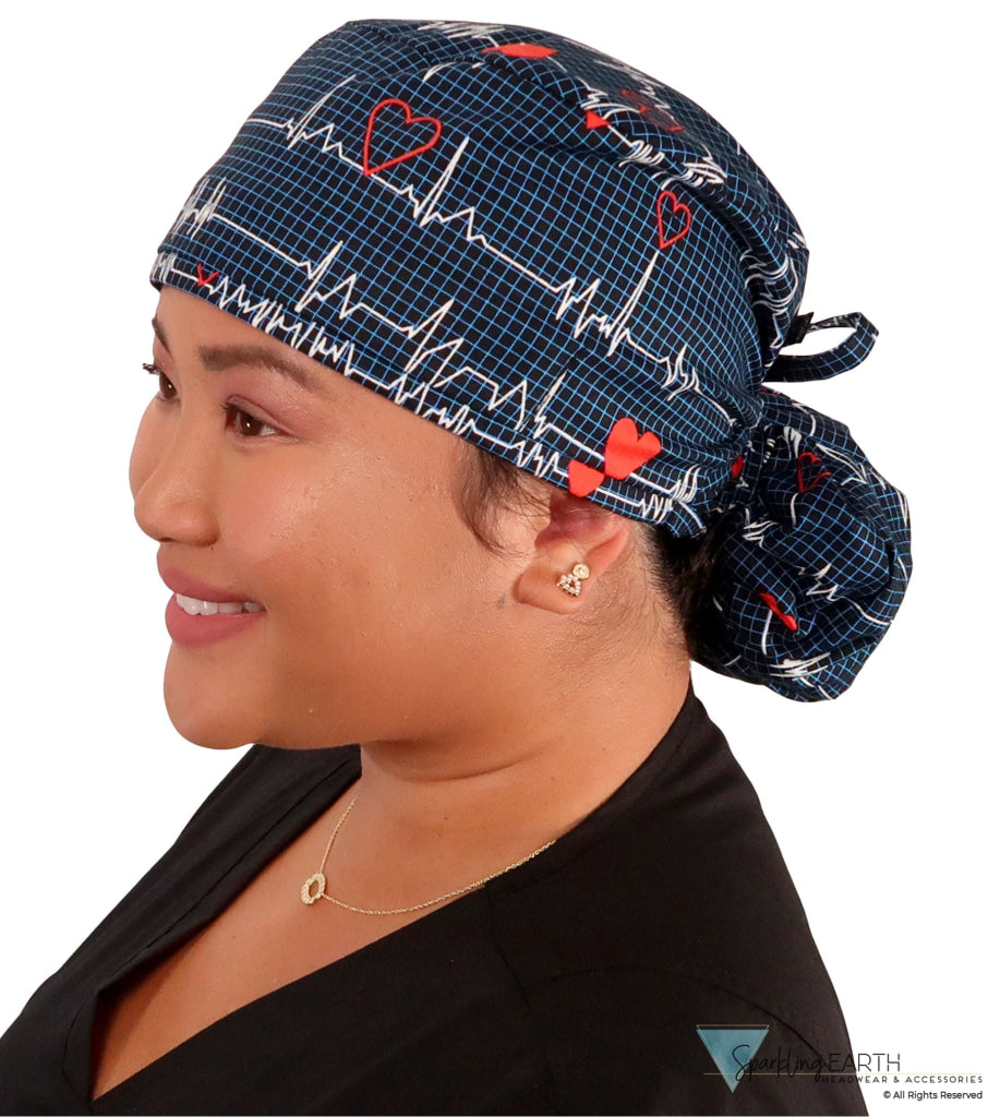 Side facing image tied of a woman in scrubs wearing a Big Hair Ponytail Scrub Cap with a Heartbeats on Navy pattern.